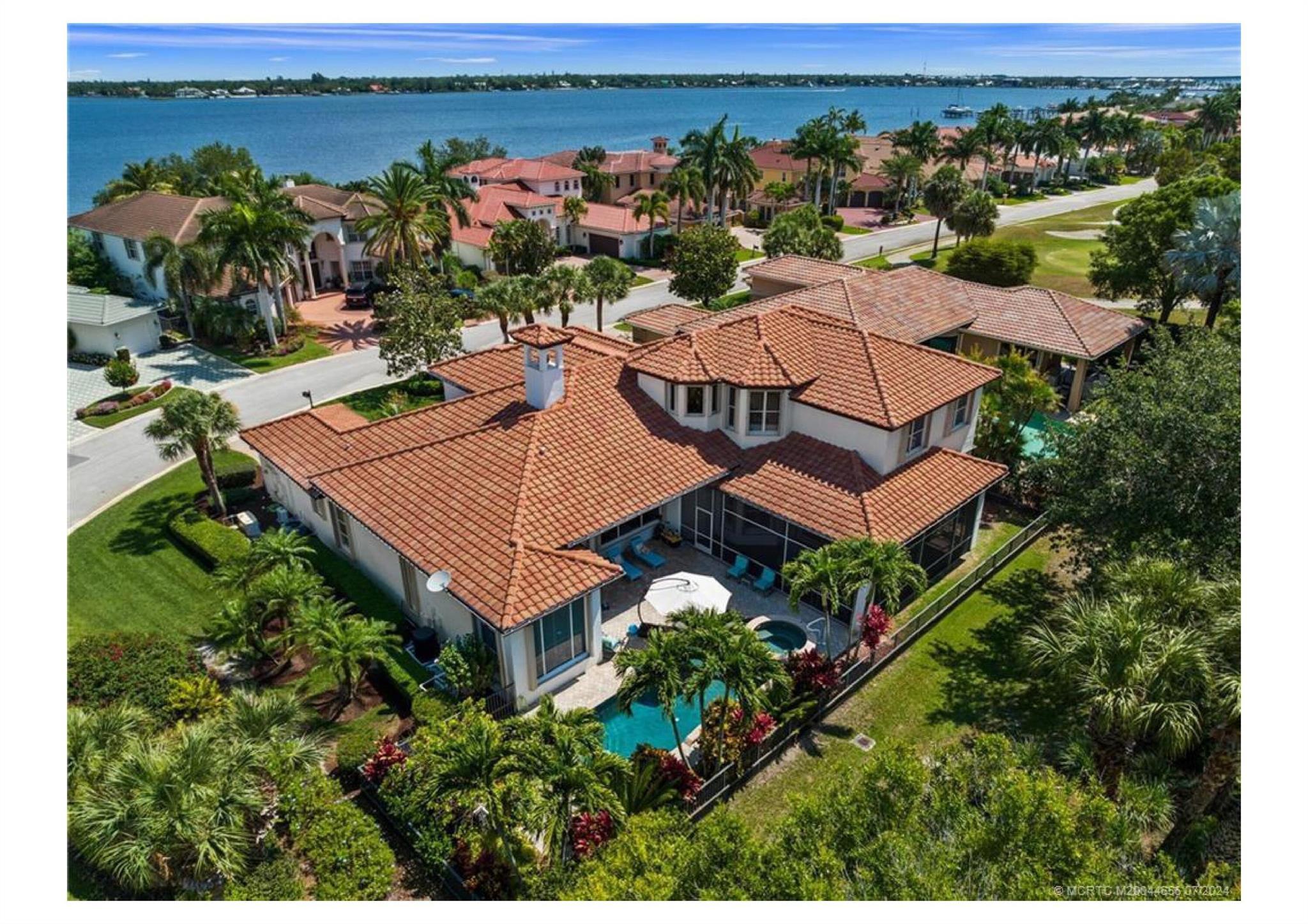 Imagine 4,600 sq. ft. of coastal luxury within Palm Cove Golf & Yacht Club's exclusive Riverfront section.  this home is more than a residence--it's an invitation to start living the story you've dreamed of!  The new kitchen is fully equipped w/premium Wolf, Subzero, Viking & Bosch appliances, merging style w/functionality. Updates like chic flooring, glass-front doors, new baths & elegant fireplace offer a polished look. EV charging outlets in the garages add modern convenience. A private oasis awaits w/a lagoon-finish pool & spa, w/heater or chiller for year round use. There's a 22 kw generator & storm shutters for peace of mind. Palm Cove's high-end amenities include a 93-slip marina, 18-hole golf course, fine dining, fitness center, pool, tennis & vibrant social calendar.