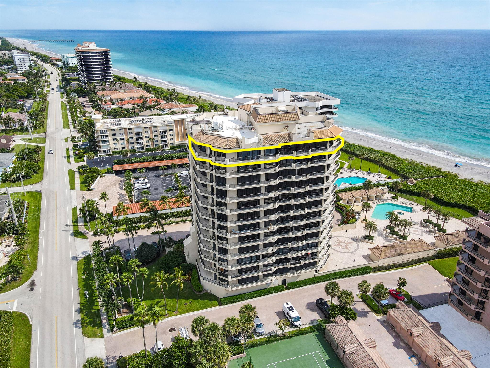 Indulge in breathtaking ocean and preserve views from this stunning penthouse oasis perched high above tranquil Juno Beach! Rarely available in the exclusive and highly sought-after Oceanfront building, this ultra-luxurious residence occupies half a floor, offering the privacy and comfort of a single-family home right on the ocean. With floor-to-ceiling glass windows replacing traditional walls, the home is bathed in natural light, providing panoramic views from every corner. Over 1,000 square feet of wrap-around balcony space invites you to enjoy outdoor living with uninterrupted ocean breezes, dazzling sunrises, and glowing sunsets. Exclusive to this penthouse is a private rooftop deck, perfect for entertaining or stargazing. Also included is a deeded cabana and an enclosed two-car garage. 
A private, keyed elevator opens to a grand double-door entrance, leading to expansive living spaces highlighted by marble flooring, and high-end finishes throughout. The gourmet kitchen features premium cabinetry, granite countertops, and top-of-the-line Thermador and SubZero appliances. The open layout allows for both formal and casual dining, with endless ocean views as the backdrop.

The lavish primary suite boasts multiple walk-in closets, a built-in vanity, and a spa-inspired bathroom with a jetted tub and a separate walk-in shower. Three additional guest suites and an oceanfront office/bedroom with custom built-ins provide serene retreats for work or relaxation. Additional features include central vacuum, hurricane shutters, remote-controlled window treatments, and a separate utility room with washer/dryer.

Oceanfront is a gated, private community offering premium amenities such as an on-site building manager, a newly updated fitness center, his-and-her saunas, a private club room, and a redesigned infinity pool with spa and beachfront access. Enjoy the luxury of your own air-conditioned, poolside cabana complete with a kitchenette, sitting area, and private bathroom with shower. With coded gates, secured elevators, and a gated underground garage, this residence provides the utmost in privacy and security, blending luxury with the best of beachfront living!