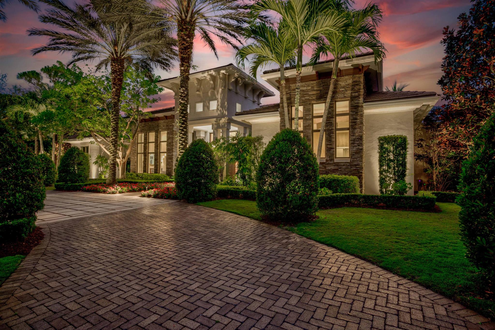 This secluded, single-story custom luxury home is situated on one of the most coveted streets in Old Palm Golf Club, where each homesite spans a full acre. Positioned at the end of a cul-de-sac and backing onto one of Old Palm's private nature preserves, this residence enjoys one of the finest lots in the community. Old Palm Golf Club, an exclusive gated enclave in Palm Beach Gardens, features a newly renovated Raymond Floyd Signature golf course, an upgraded clubhouse, and a state-of-the-art 20,000-square-foot lifestyle center. Club amenities include a new fitness center, spa, resort-style pool, lap pool, fine dining, sports bar, and guest casitas. All these exceptional features are just moments from your doorstep. This is a very private lot with a backyard oasis that faces due south, ideal for southern exposure. There is an extra large covered logia that includes a full outdoor kitchen with a gas grill, ice maker, and bar that seats seven, a dining space, and a living room space in front of a fireplace with a television above.  Walk off the covered space to a custom heated pool and spa with a tranquil rock waterfall and relax by the firepit with your favorite glass of red under the stars, or enjoy the 1,100sf synthetic turfed putting green and synthetic chipping stations strategically placed around the yard. With over an acre of land and large fenced in backyard of zoysia grass, there is ample entertainment for everyone at this perfect recreational venue.  

The grounds themselves are absolutely stunning! Every attention to detail has been paid to this meticulous landscape package. Lazy oaks and magnolias adorn the front yard, giving the front elevation a modern low country feel. In the evenings, the landscape comes alive with a new, state-of-the-art low voltage system of lights that turns this backyard into pure paradise. Perfectly positioned flowers, annuals, and shrubbery finish the look and give this home the feel of a perfectly manicured estate.

The home's interior is modern, spacious and open. There is a lot of natural light with the oversized sliding glass windows and doors that are all impact. The custom ceiling details feature a combination of fine crafted level 5 drywall coffers and solid maple and mahogany beams. The millwork package is second to none, and this home's additional spaces include a study, gym, custom fireplace, wine room and a home theater with upgraded electronics. Equally as impressive is the large open kitchen with double islands, double sinks, double dishwashers, professional grade Thermador appliances, a reverse osmosis water filtration system, quartz counters and custom wood cabinetry. Just off the kitchen and family room is the wet bar, perfect for entertaining inside and out including both an icemaker and wine refrigeration. Music can be played throughout this beautiful home with the included Sonos Wi-Fi controlled sound system. 

For those who love to entertain overnight guests, this residence features a true guest wing with a private entrance, formal living room, breakfast bar and 3 private guest suites, each with its own full guest bath. 

Both the the living room and kitchen have just been totally refurbished and updated. The roof is brand new, the washer/dryer, ice makers, and the outdoor refrigerator are new, 4 A/C units were installed in 2022, tankless water heaters and a water filtration system also installed in 2022, and new interior and exterior paint throughout that embraces the entire home. New low voltage landscape lighting encompasses the entire property, plus new landscaping, and all new epoxy garage floors.  If the power goes out, do not despair. This home is backed up with a full house Generac Generator. 

The Old Palm Golf Club membership is available, but not mandatory for this home. Look no further... you have found paradise!