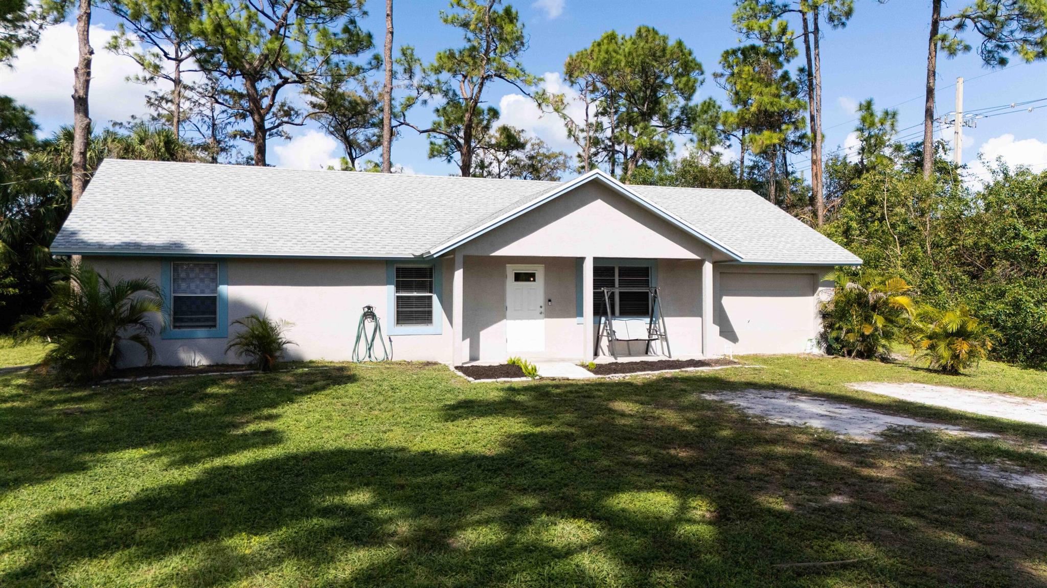 Welcome to your Palm Beach retreat! This fantastic 4-bedroom, 2-bathroom home is set on a spacious 1.3-acre corner lot, perfect for outdoor fun and relaxation. With a new roof from 2022 and a new AC system installed in 2023, you'll stay comfortable year-round. The home also features a new water filtration system for fresh, clean drinking water. Inside, you'll find a completely updated space that feels bright and inviting. Plus, the 1.25-acre easement next door can't be built on, giving you plenty of privacy and a peaceful atmosphere. Enjoy the best of Palm Beach living in this welcoming home!