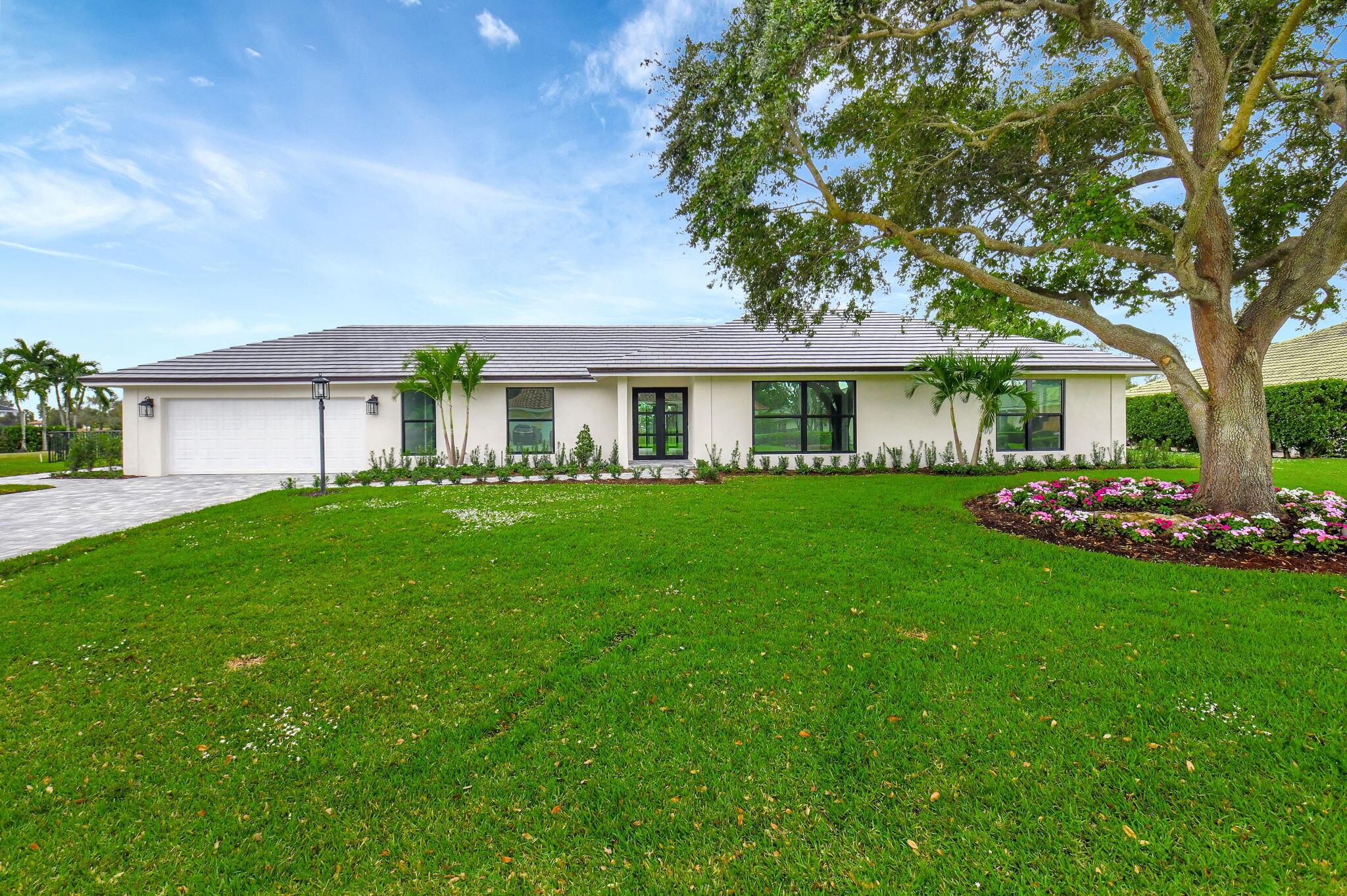 This magnificent executive home is now Complete! This modern and elegant home has been remodeled from the ground up!  This is as close as you can get to a newly built home- as everything has been meticulously redone, electric, plumbing, roof, kitchen, baths, drywall, stucco, landscaping, fence, new pavered driveway and patio, and new modern impact windows and doors. This oversized lot has one of the best views of the golf course you are ever going to get, and the huge fenced in backyard with new paver patio has plenty of room to add a pool and putting green! This estate offers 3 bedrooms plus an office/4th bedroom and 3.5 bathrooms. The spacious floor plan includes a chef's dream kitchen with an expansive island opening up to the living room, all new modern fixtures, cabinets, appliances