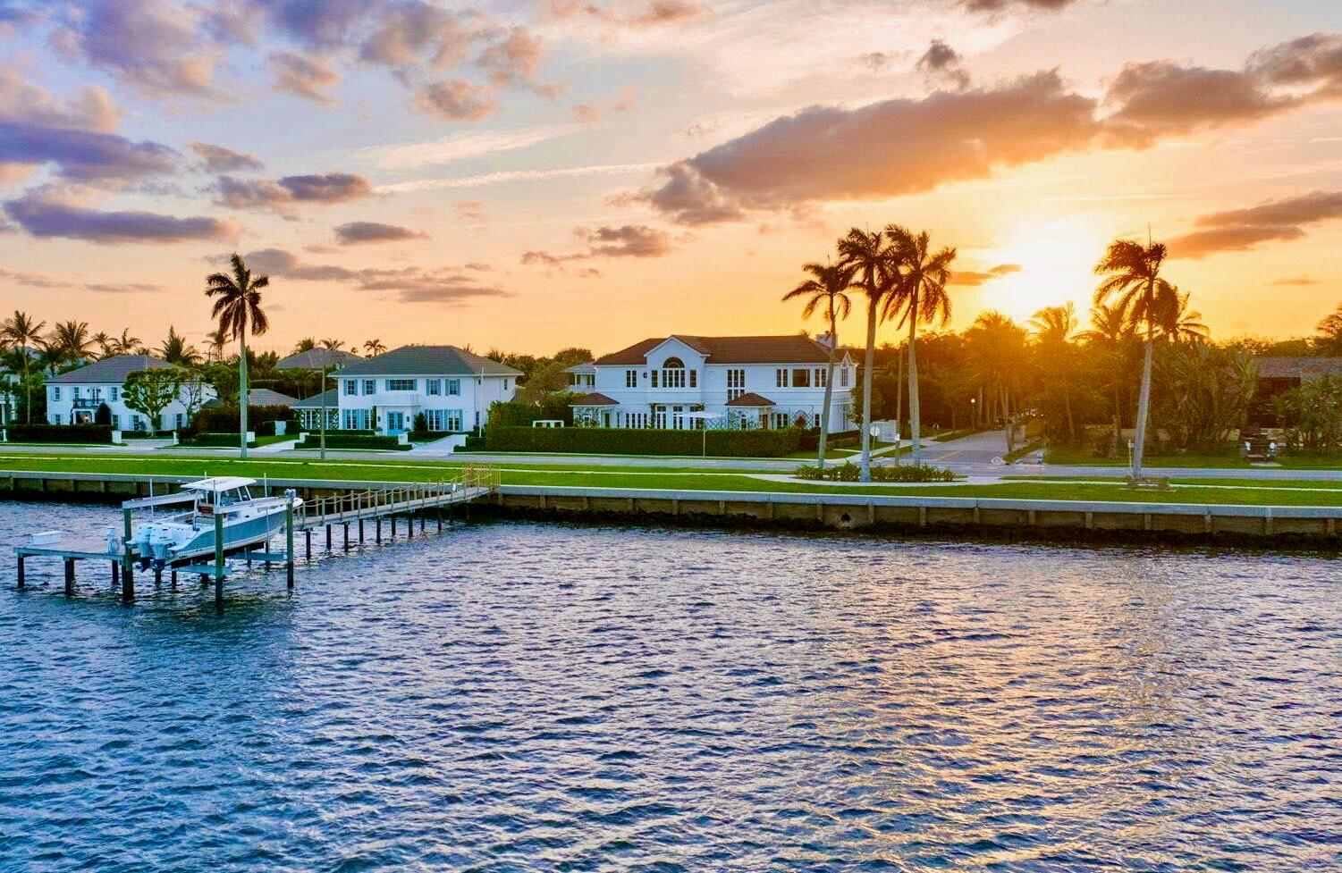 IMPRESSIVE INTRACOASTAL ESTATE INCLUDING ITS OWN PRIVATE DOCK & BOAT LIFT. Newly renovated with every luxury for the discerning buyer, this 5-bed, 4.2-bath home offers breathtaking views of the widest part of the Intracoastal Waterway from all main rooms. Featuring 11-ft ceilings, 6,000 total square feet of meticulously redesigned living space, and a desirable semi-attached guest house. A sprawling primary suite complete with oversized dual dressing rooms with Italkraft closets and custom cabinetry. This home has an abundance of natural light, high-end finishes, and every conceivable amenity for those who love to entertain. The open kitchen features premium Wolf and Subzero appliances. The very impressive waterfront bar/lounge features LED backlit crystalline quartzite... ...a stunning brass sink, ice maker, and custom cabinetry. This sophisticated 2-story home also includes a guest apartment for extended stays or ultimate privacy. Every element of this home is crafted for luxury living: wine wall, putting green, gated driveway, full house generator, integrated smart home system, and elevator. Perfectly located near Palm Beach Island, PBI Airport, premiere shopping, dining, and more. An adjacent lot is also available for purchase, offering unparalleled potential for expansion. This is a rare opportunity to own one of SoSo's finest estates!!!