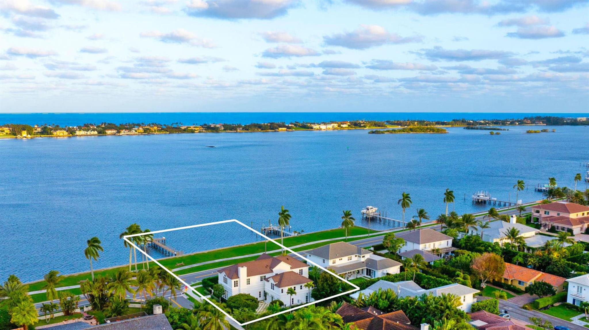 IMPRESSIVE INTRACOASTAL ESTATE INCLUDING ITS OWN PRIVATE DOCK & BOAT LIFT. Newly renovated with every luxury for the discerning buyer, this 5-bed, 4.2-bath home offers breathtaking views of the widest part of the Intracoastal Waterway from all main rooms. Featuring 11-ft ceilings, 6,000 total square feet of meticulously redesigned living space, and a desirable semi-attached guest house. A sprawling primary suite complete with oversized dual dressing rooms with Italkraft closets and custom cabinetry. This home has an abundance of natural light, high-end finishes, and every conceivable amenity for those who love to entertain. The open kitchen features premium Wolf and Subzero appliances. The very impressive waterfront bar/lounge features LED backlit crystalline quartzite... ...a stunning brass sink, ice maker, and custom cabinetry. This sophisticated 2-story home also includes a guest apartment for extended stays or ultimate privacy. Every element of this home is crafted for luxury living: wine wall, putting green, gated driveway, full house generator, integrated smart home system, and elevator. Perfectly located near Palm Beach Island, PBI Airport, premiere shopping, dining, and more. An adjacent lot is also available for purchase, offering unparalleled potential for expansion. This is a rare opportunity to own one of SoSo's finest estates!!!