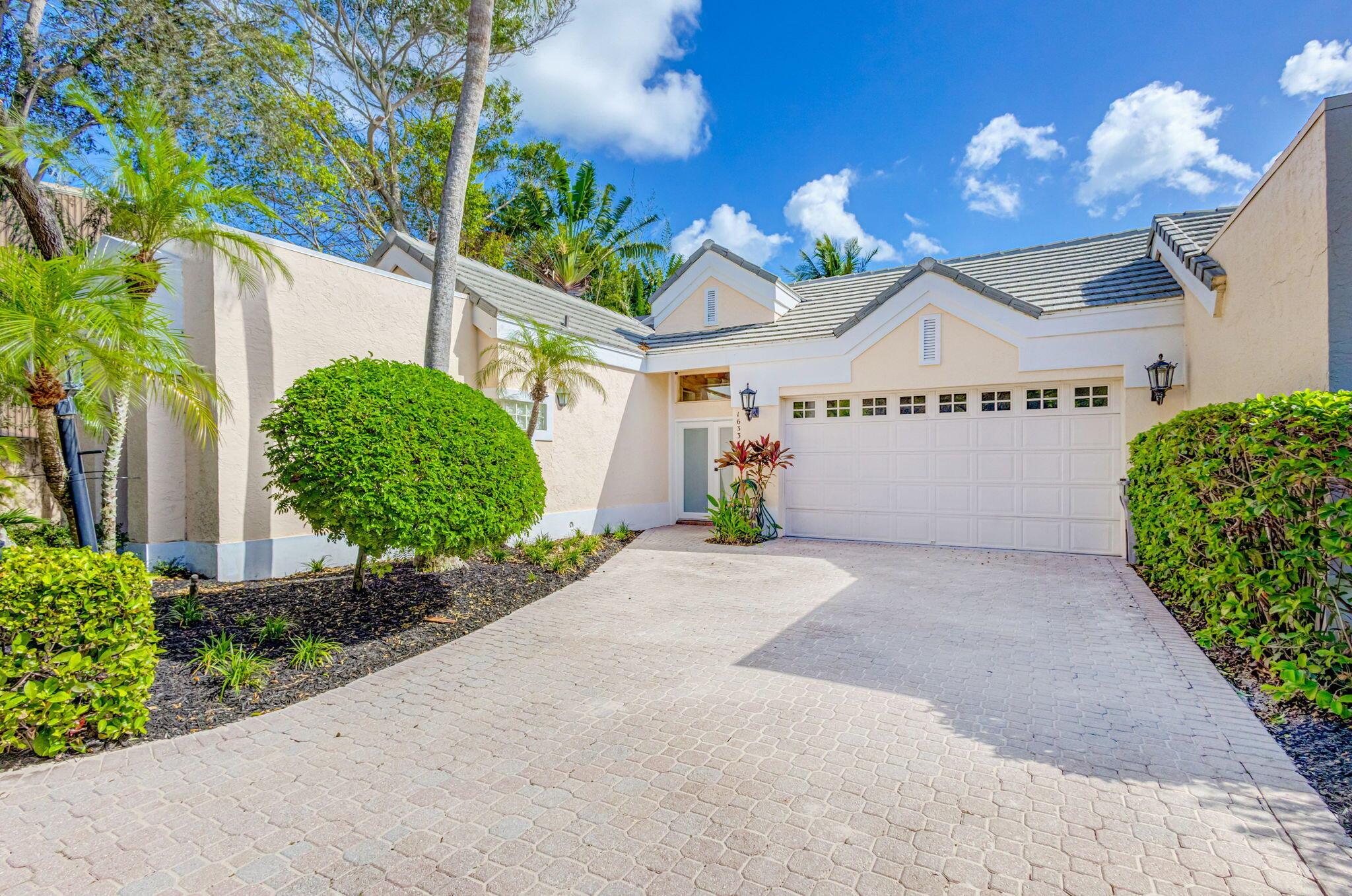 This absolutely stunning WATERFRONT courtyard home sits directly on the Intracoastal! Includes Private DOCK w/ water & electric,16,000lb lift + more space to tie up, 2 jet ski lifts & private stairs to beach! Home features include ROOF 2019, Impact windows & doors, separate guest house with bath & kitchenette, screened courtyard with heated pool/waterfall spa & a summer kitchen. The first floor of the home features high ceilings, big windows with incredible Intracoastal views, a spacious kitchen & family room that opens to the pool and the stunning primary suite with it's own access to the patio and water views. Both bedrooms upstairs have private baths, one with water views. Sprawling rear greenspace leads to the water. Amazing community with club memberships available but NOT required.