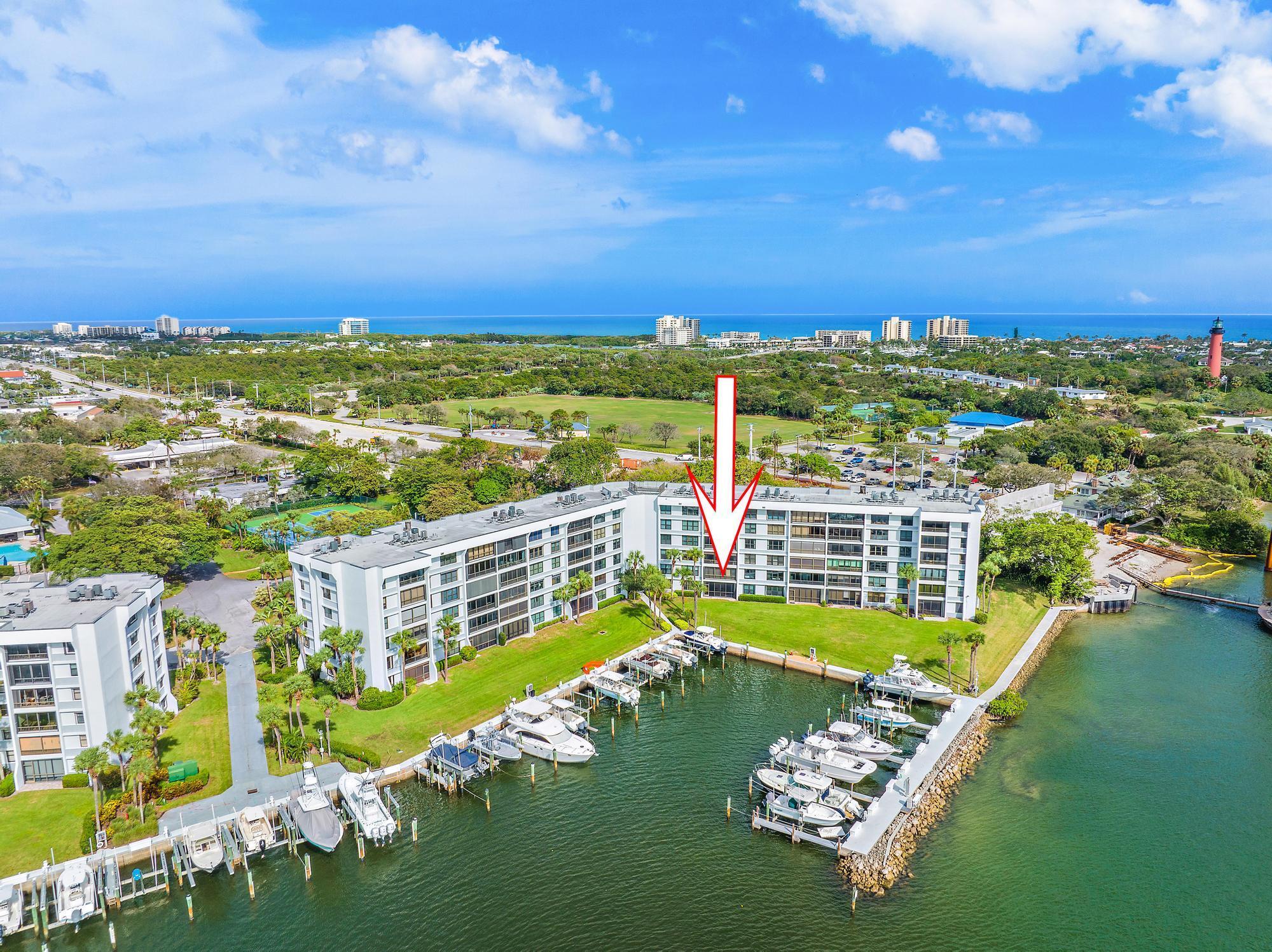 Enjoy amazing views of Jupiter Inlet and the Intracoastal from this gorgeous waterfront condo in Jupiter Cove.  The Loxahatchee River, Jupiter Inlet and the Intracoastal all converge, offering easy access to the Atlantic Ocean. Step out the back door to your private marina, or simply relax and enjoy Florida sunset views from your porch.This ground floor unit is updated with beachy neutral colors, brand new appliances, and luxury vinyl plank flooring. New A/C and Water Heater installed in 2022.Jupiter Cove marina offers boat slips up to 40' for rent or purchase when available. Tennis, Pickleball, kayak storage, swimming pool, clubhouse, onsite management and gated security. Grill out at the waterfront Tiki Bar with a private beach perfect for wading out to the sandbar.