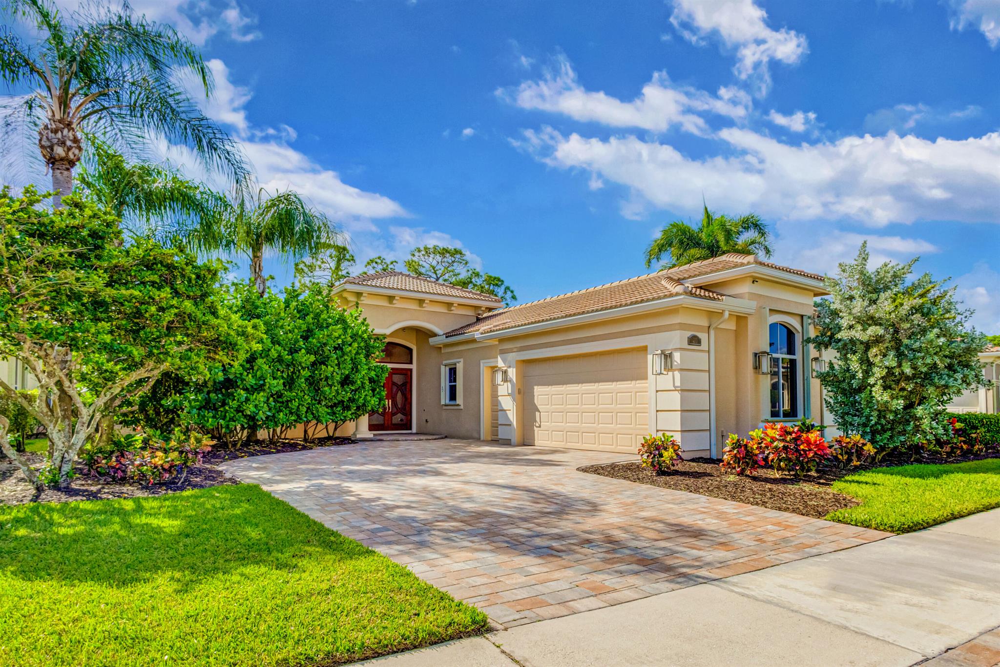 Step into a world of elegance and sophistication, in Mirasol Country Club in Palm Beach Gardens. Every corner of this residence exudes luxury, with meticulous attention to detail and modern comforts, making it the perfect sanctuary for discerning buyers. From the moment you arrive, the allure of this home captivates with Waldorf Astoria-inspired porcelain floors that flow seamlessly throughout the open layout. Enhanced by alabaster chandeliers and sconces, the ambiance is both warm and inviting. Equipped with night lights, recessed LEDs, and ceiling fans in every room, this home is designed for comfort and convenience. Every element is current, driveway, roof which provide peace of mind. Safety is paramount, with five outdoor surveillance cameras and sensors on all doors and windows, ....respectively&#x14;provide peace of mind. Safety is paramount, with five outdoor surveillance cameras and sensors on all doors and windows, complemented by six indoor motion sensors. The property is equipped with a Kohler whole-house generator and features elegant Craftsman exterior lighting that frames the home beautifully. The heart of the home is a spacious family area featuring a striking layered granite media wall, perfect for family gatherings. In the living room the electric theater shade and alabaster sconces create an atmosphere that is both cinematic and cozy. Adjacent to the living room is the dining room a perfect space for entertaining. The gourmet kitchen open to the family room is a chef's dream, featuring an impressive 8' x 4' kitchen island adorned with exquisite quartz countertops. Two-tone African Mahogany cabinets provide ample storage, while under-counter LED lighting and an elegant full backsplash elevate the aesthetic. New Bosch appliances, including an oven, warmer oven, and dishwasher, along with a Miele range with a grill, ensure culinary excellence. The KitchenAid French door refrigerator and Kohler Titanium kitchen faucet complete this state-of-the-art kitchen, making meal preparation a joy. Retreat to the spa-like primary suite. The bathroom, offers a marble shower with alabaster sconces beckons relaxation. The space is adorned with African Mahogany cabinets featuring wainscoting, a luxurious bubble tub, and a mirrored cabinet medicine chest. Grohe rain shower hardware and custom tilework provide an indulgent bathing experience. The tranquil primary bedroom with 2 spacious built in closets offers view of the lush private outdoor paradise. Each guest bedroom suite is designed for tranquility, with birch closet doors and window sills. Your guests will feel pampered in the guest bathroom, which boasts a Waldorf Astoria-inspired quartz countertop, alabaster sconces, and a mirrored cabinet medicine chest. The Toto elevated universal toilet and adult-height counters, offers comfort and elegance. Pocket and barn doors offer privacy and seamless access to the bathrooms. Practicality meets style in the laundry room, featuring a quartz countertop with sink and shelving that reaches the ceiling. The commercial-grade electric Speed Queen washer and dryer (new in 2020) make laundry days effortless, while thoughtful shoe shelving adds organization. Step outside to your own private oasis, featuring new pool equipment and a travertine pool deck that is perfect for sunny days. Hand-painted patio wall art imported from Tunisia adds a unique touch, while 25 new trees, including silver buttonwood and palm, enhance the lush surroundings. The spacious garage features a composite floor, shelving for organization, and air circulation fans to keep the space comfortable. Two bike hoists provide convenient storage for your outdoor adventures. Stay cool and comfortable year-round with two new HVAC systems installed in 2020, ensuring efficiency and reliability. This stunning home, with its luxurious upgrades and thoughtful design, awaits your arrival. Experience the perfect blend of elegance, safety, and comfort. . Mirasol Country Club is one of Palm Beach Gardens' most coveted country clubs, boasting a 75,000 square foot clubhouse with multiple indoor and outdoor dining venues, a full-service spa, a state-of-the-art fitness center, a dedicated kids' clubhouse, tennis and pickleball courts, an Olympic-sized pool, kids pool, additional secluded pool and two championship golf courses. This vibrant community offers an array of social activities, special interest clubs and events, ensuring a dynamic lifestyle for its residents.