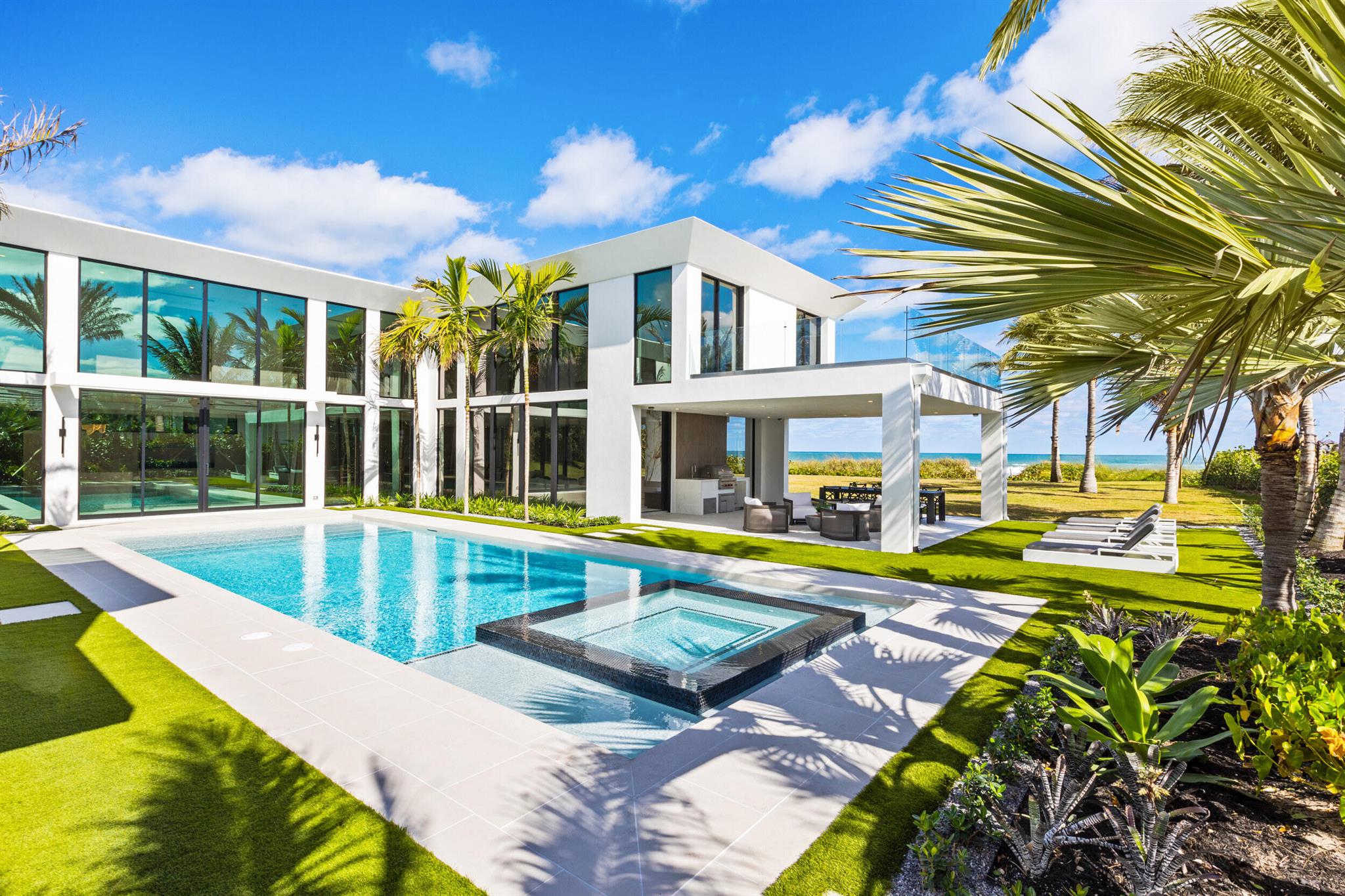 Discover the rare allure of a brand-new beachfront gem on the pristine shores of Jupiter Island. This stunning contemporary residence, with 6,500 square feet of meticulously crafted, air-conditioned living space, offers uninterrupted ocean views from every corner. Featuring five spacious bedrooms and five and a half elegantly appointed bathrooms, this concrete and steel constructed fortress is a true masterpiece of modern design. It seamlessly combines style with functionality, boasting floor-to-ceiling glass throughout that captures breathtaking views and fills the home with natural light. Created with the finest materials and exquisite finishes, this architectural marvel is the vision of the esteemed Affinity Architects, brought to life by one of the top local builder, Coastal Property Every element of this home reflects a commitment to unparalleled quality and timeless elegance, creating an oasis where you can unwind and embrace the ultimate seaside lifestyle.
Listed at $21,000,000, this property is more than a home; it's an invitation to own a private piece of paradise in one of the world's most exclusive coastal settings. Jupiter Island is renowned for its serene, luxurious ambiance, with fewer than 500 homes gracing the barrier island and offering expansive acre plus lot size with the Atlantic ocean to the east and the Intracoastal to the west. Jupiter Island provides a haven of refined tranquility for those seeking an elevated lifestyle. Despite its peaceful seclusion, Jupiter Island is close to upscale shopping, fine dining, world class golf clubs and accessible airports, perfectly balancing tranquility with convenience. Jupiter Island offers a lifestyle beyond compare, cherished by the world's elite and now awaiting you. Seize your chance to make this dream home your reality.