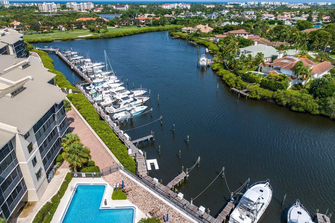 SELLER HAS PAID THE $80,000 ASSESSMENT IN FULL. Nestled within the prestigious gated country club community of Jonathan's Landing in Jupiter, with 3 championship golf courses, tennis, fitness center, clubhouse and full-service marina, this updated luxurious two-bedroom, two-bath condo offers an unparalleled lifestyle. Overlooking a serene lagoon and the manicured greens of the golf course, the condo provides a breathtaking vista and delightful breezes that can be enjoyed from the comfort of your own home. The spacious open concept living area is bathed in natural light, creating an inviting and relaxed atmosphere. The split floorplan with two well-appointed bedrooms ensures ample space for comfort and privacy.The Chef's kitchen has stainless steel appliances and spacious breakfast bar . With easy access to the Clubhouse, the club's amenities promise a life of leisure and recreation. Boating enthusiasts can dock your boat below your condo in the Anchorage's own private marina. Other amenities include covered garage parking, golf cart garage, storage area and large pool with cabana and stunning water views. With access to world class golfing and a host of community features, this condo embodies the epitome of Florida living at its finest. Club membership is not mandatory.