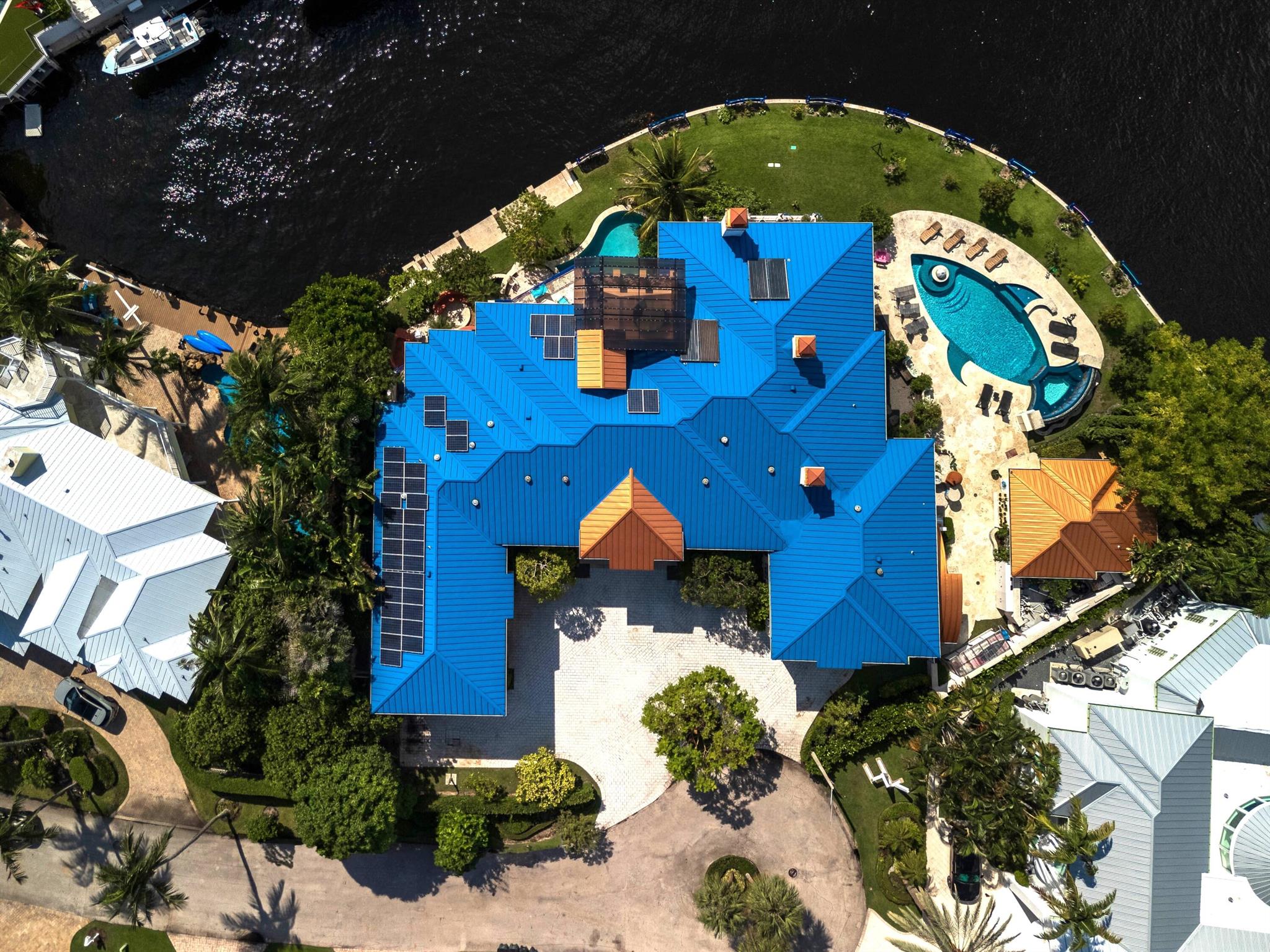 This Magnificent Estate is truly a Work of Art and situated on a Direct Intracoastal Point Lot with 256 ft of Waterfrontage and .53 Acres. Built of John Ross/ ROSSCO Const, the beauty of the lot is that it is sited on an expansive Nautical turn of the Intracoastal so it captures the gorgeous long North views. The home features over 16,600 total sq ft with 12 bedrooms, 6 fireplaces and 3 pools, one incredibly shaped like a fish, another with a ''swim against machine'' and one for pedicure fish. As you enter the grand foyer you notice the stunning tile mosaic floors, murals and painted ceilings all done by renowned French painter.  There are 2 staircases, one with Marble & tile work by a Canadian Artist and banister designed by a metal artist and the owner, the other is a tree staircase