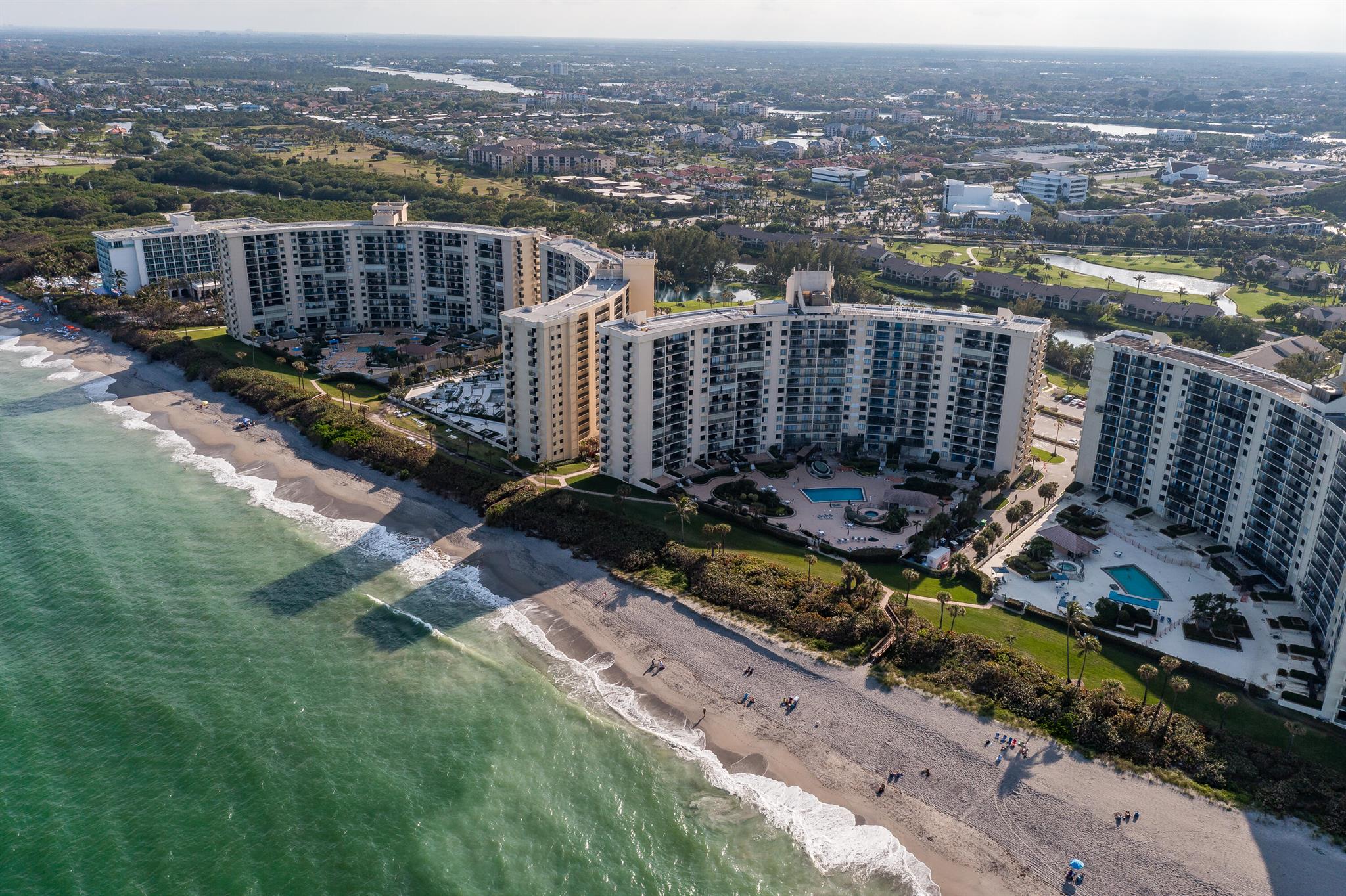 ALL assessment for this building have been paid by Seller.  Ocean Front Living at it's Best!  Directly on the beach with no streets to cross to the sand. Two bedroom, 2 bath condo with tile floors throughout. One of the best views in this building. Also included in the unit is a stackable washer dryer. A/C 3 years old. Ocean Trail has 24 hour manned guard gate, secure under building assigned parking, storage, pickle ball, heated pools, spa, sauna and fitness room.  The catwalk features the city view of Jupiter. Near many restaurants and entertainment.  Come live the Beach Life!