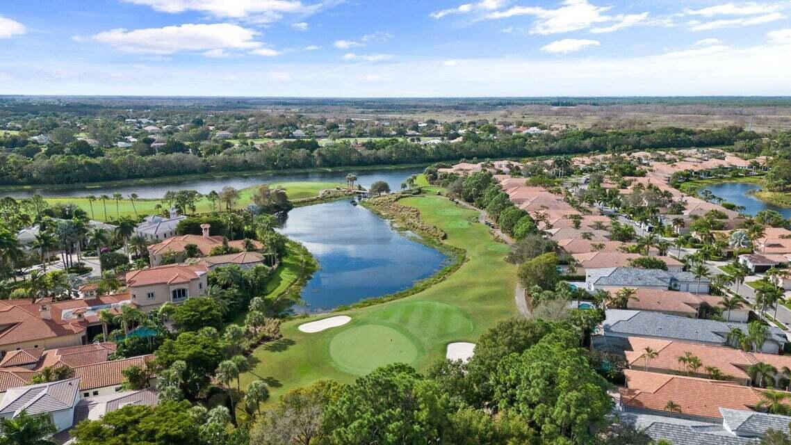 Golf Membership . This inviting 3 bedroom, 3 bathroom home offers stunning views of the 6th green on the Sunset Course at prestigious Mirasol Country Club, all within walking distance to the Clubhouse. Surrounded by lush tropical landscaping, the property provides a serene golf course backdrop. The open and spacious floor plan is perfect for relaxation, filled with natural light and enhanced by impressive 14-foot tray ceilings. Recent upgrades add to the home's appeal, including a newer AC unit, primary bedroom closet, fresh interior paint, accordion shutters on side windows, and hurricane impact windows and doors at the front and back. Additional enhancements include updated door hardware, electric roller shades, window treatments, and remodeled bathrooms and laundry room tops. A spacious pantry was added in the kitchen. Enjoy the exceptional amenities of Mirasol Country Club, which include a luxurious spa and fitness center, 15 clay tennis courts, pickleball courts, two championship golf courses, a practice range, a family sports complex, special interest clubs and a full calendar of year-round social events.