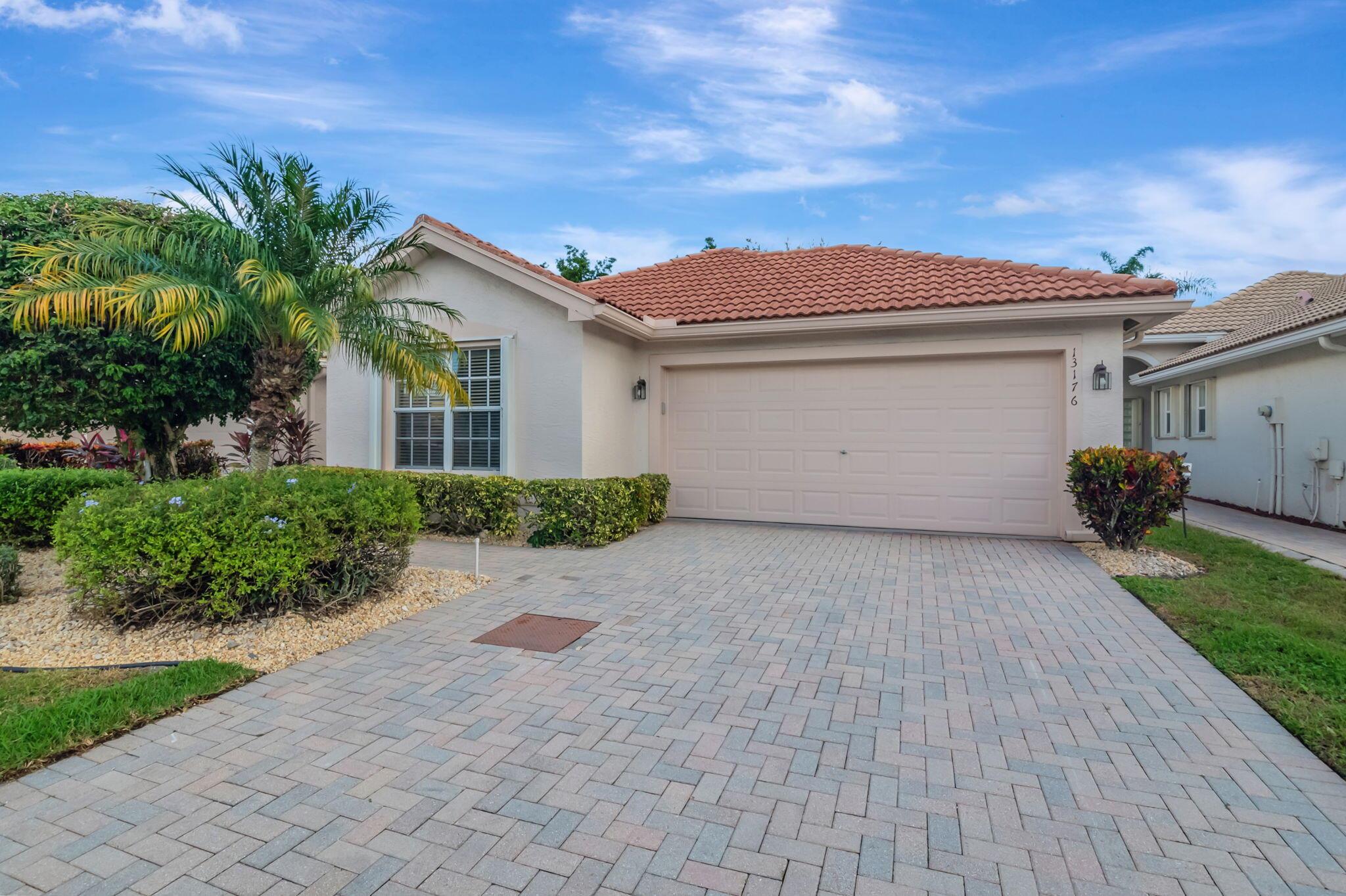 This move-in ready home has been expertly maintained and well cared for. Feel safe and secure with the reassurance that your home is protected by a whole house propane generator, as well as accordion shutters throughout, for peace of mind all year round. This original Valencia Falls homeowner selected several upgrades when designing this home, including an extra wide entry path with no step at the front entrance. In this ''Majestic'' layout the primary bedroom, living room, and patio all have views to the private quiet backyard. The den/office/3rd bedroom has professionally designed custom built-in desk and shelving. White porcelain tiles laid on a diagonal have recently been steam cleaned and look brand new. Many appliances have been upgraded, including newer washer and refrigerator, and brand new dishwasher. This interior been freshly painted, and recessed lighting throughout the residence provides a clean, bright look. The laundry room is conveniently located and includes a deep utility sink, and the spacious kitchen offers an eat-in breakfast nook. This Premier 55+ community offers an active Florida lifestyle, and the clubhouse is undergoing a multi-million dollar redesign and renovation with completion in 2025. Join your neighbors for a friendly game of tennis or pickleball, or relax poolside and soak up Florida's exceptional weather. This secure gated community is pristinely maintained and the HOA is well-managed. Ideally located a short drive to many dining, cultural, and shopping options, with easy access to the Turnpike. Be sure to put this one on your list to see!