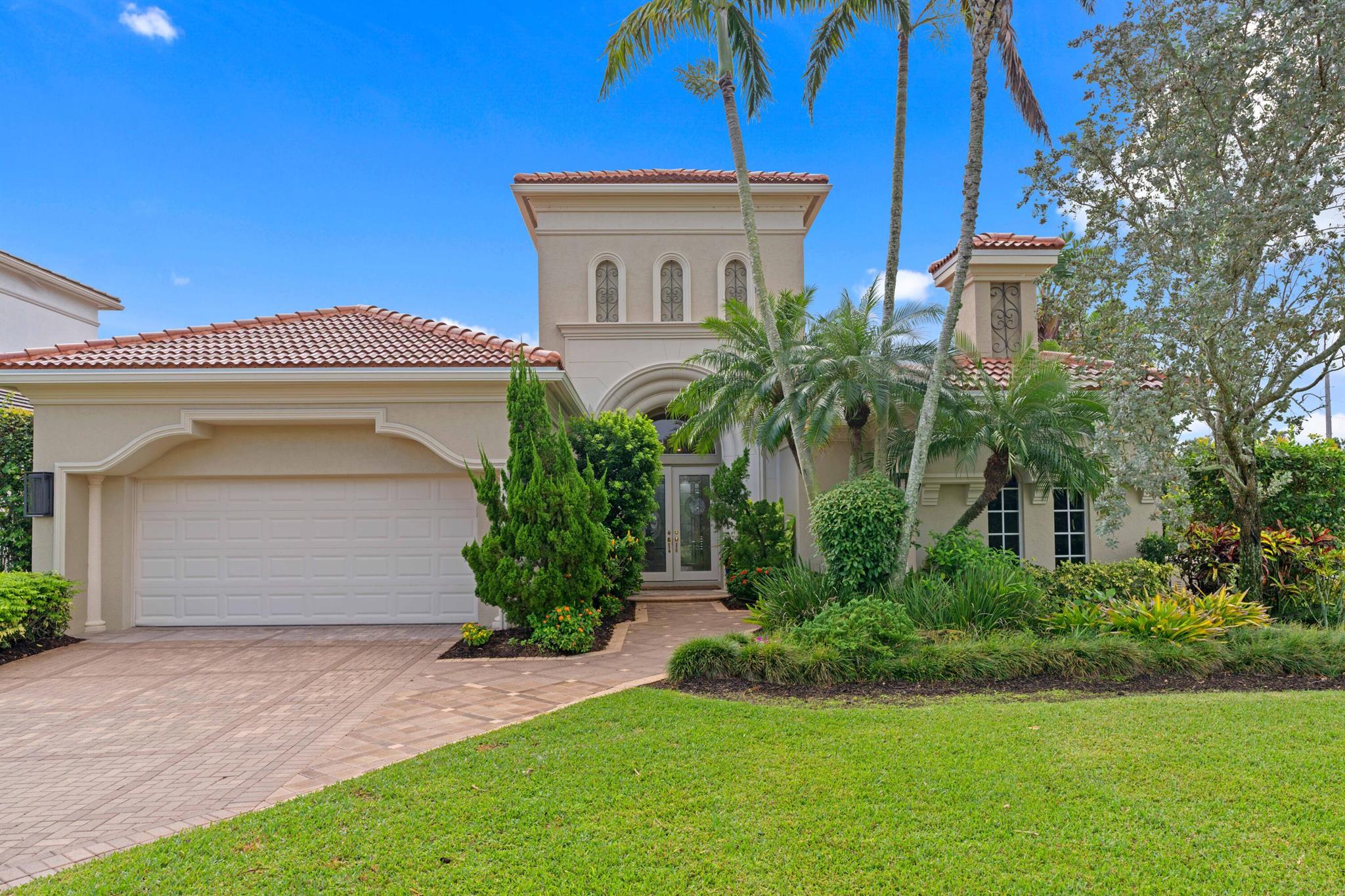 Soothing golf and water views greet you from every angle in this rarely available Bernini model. Located on Via Paradisio's cul-de-sac, this one-story home has three en-suite bedrooms, plus an office. Intelligently laid out, designed by Kemble Interiors, this home exudes modern-Mizner vibes with its renovated kitchen, NEW ROOF,  new appliances (including whole house generator and water filtration), expanded driveway, motorized hurricane protection, golf cart garage and more. Southern exposure in the back. Lush, expansive gardens and pool area. A quarter of an acre lot. Seconds from the West gate and the award winning Mirasol Country Club. Walk or cart to tennis, golf or gym. Some furnishings negotiable. Sports membership. Don't miss this one!