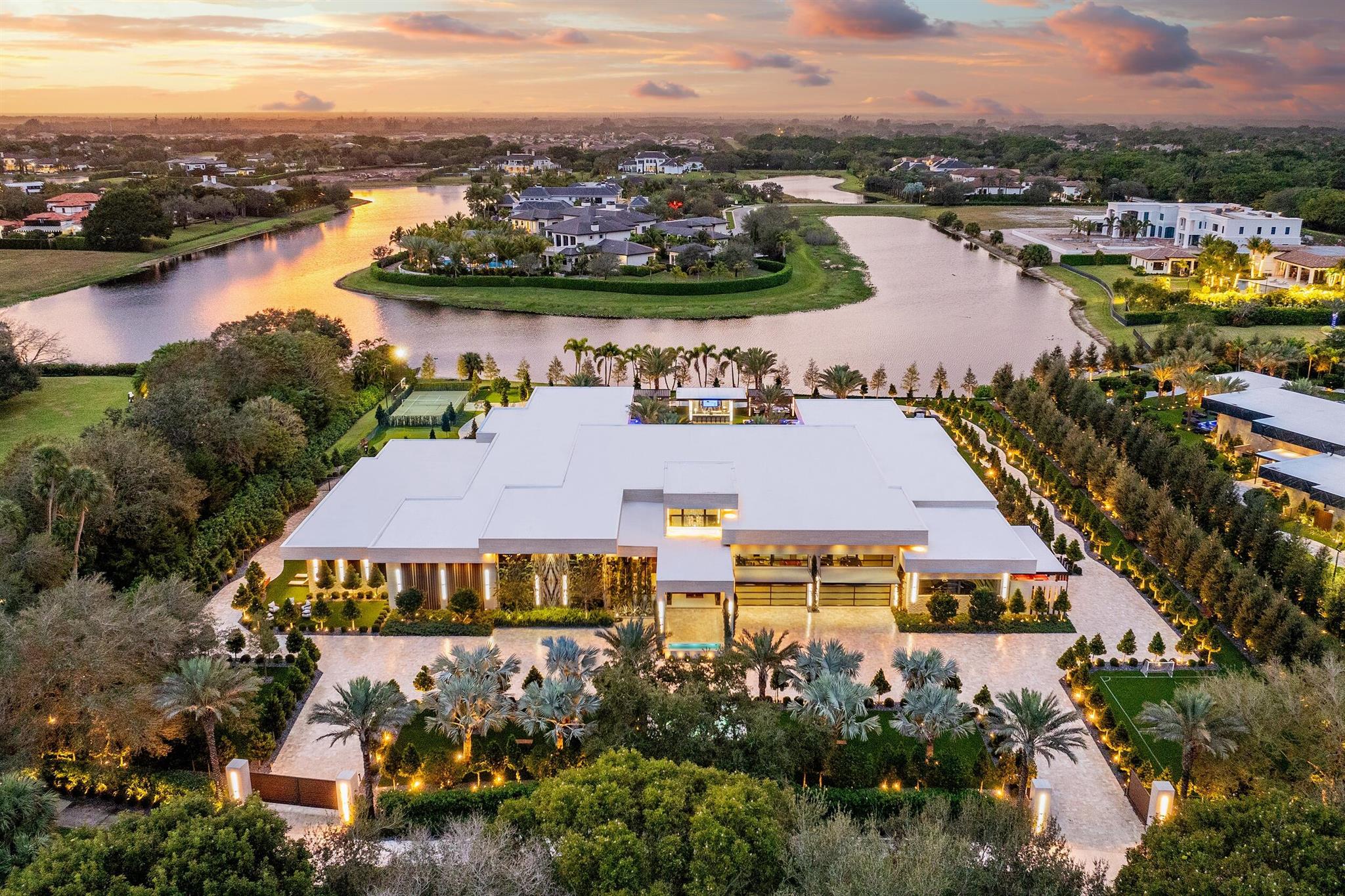 Welcome to Casa Maranello, an extraordinary residential masterpiece and one of the most distinguished estates in the United States. This ultra-luxury Italian contemporary residence is situated in the exclusive Stone Creek Ranch of Delray Beach, Florida, and is a true paradise for Ferrari enthusiasts.This trophy estate epitomizes ultra-luxury with a timeless contemporary design and unmatched sophistication. Crafted with the finest materials, equipped with lavish amenities, and infused with the passion of a Ferrari collector, this estate is a seamless blend of elegance and innovation. The fully gated resort-style property ensures unparalleled security and privacy. Set within the prestigious Stone Creek Ranch, known as "Billionaire's Row," this estate spans 21,725 square feet and is set on a 2.5-acre lakefront sanctuary at 16171 Quiet Vista Circle in Delray Beach, Florida. The property showcases soaring ceilings and expansive panoramic views of the lake and grounds, all within a thoughtfully designed single-story layout.

Meticulously curated by Aldo Stark of Prestige Design Homes, Casa Maranello comes fully furnished with a sophisticated blend of modernity and timeless elegance, presenting a true showpiece of luxury design and execution. More than just a residence, Casa Maranello embodies the essence of exceptional living, where every detail celebrates a commitment to excellence and style. Inspired by European artistry and precision, this estate is a true collector's dream.

The grand salon is a true showpiece, featuring soaring ceilings, bespoke crystal chandeliers, and stunning views of the resort-style pool. The adjacent Maranello Bar offers an unparalleled entertainment experience, as well as an elegant dining area highlighted by a striking 20-person Brazilian Onyx dining table, perfect for hosting lavish gatherings.

This estate includes 6 bedroom suites including two expansive primary suites, each with boutique style closets and spa-like en-suite bathrooms that provide a private sanctuary, balancing sophistication with tranquility. Additionally, four finely appointed guest suites ensure ultimate comfort and privacy for family and friends. A spectacular office with the concealed bathroom also features a great view of the car gallery. 

For the Ferrari aficionado, the estate's 12-car gallery garage is a dream realized, showcasing automotive masterpieces with style and reflecting the Ferrari-inspired legacy that sets this home apart.

The residence boasts an array of amenities designed for both relaxation and recreation. Indoors, a Bulgari hotel-inspired spa features an indoor pool, a Himalayan salt room, steam room, and sauna, creating a private retreat that rivals the world's most exclusive resorts. Adjacent to the spa is a fully equipped gym for complete fitness convenience.

A state-of-the-art home theater with 12 plush seats delivers an unparalleled cinematic experience, while the dedicated recreation room, bar, and private salon make entertaining and personal care seamless luxuries.

At the heart of the home is the gourmet kitchen, equipped for culinary excellence and designed for the most discerning tastes. The property includes both a family kitchen and a separate chef's kitchen with a private staff entrance. 

Outdoor living at Casa Maranello is equally spectacular. The resort-style 95-foot pool and spa are complemented by a fully equipped cabana with a private bathroom, kitchen, and bar, perfect for hosting memorable alfresco events. For sports enthusiasts, Casa Maranello features a basketball/pickleball court, a private soccer field, and a putting green, offering endless opportunities for recreation.

Winding walking paths, serene water features, and meticulously maintained landscaping create a tranquil atmosphere, turning the property into a true oasis. The exterior exudes serenity, with Italian cypress trees, palms, and bougainvillea that impress by day and transform into a cinematic landscape by night, enhanced by strategic lighting and the soothing sounds of water fountains.
Inspired by the elegance and thrill of a Ferrari road trip through the breathtaking landscapes of Italy and Switzerland, this home embodies the excitement of navigating the iconic Goldfinger route. Every aspect of its design captures an atmosphere of adventure, exclusivity, and timeless luxury. Guided by the spirit of Enzo Ferrari's words, "If you can dream it, you can do it," this residence is a testament to visionary living and refined sophistication.