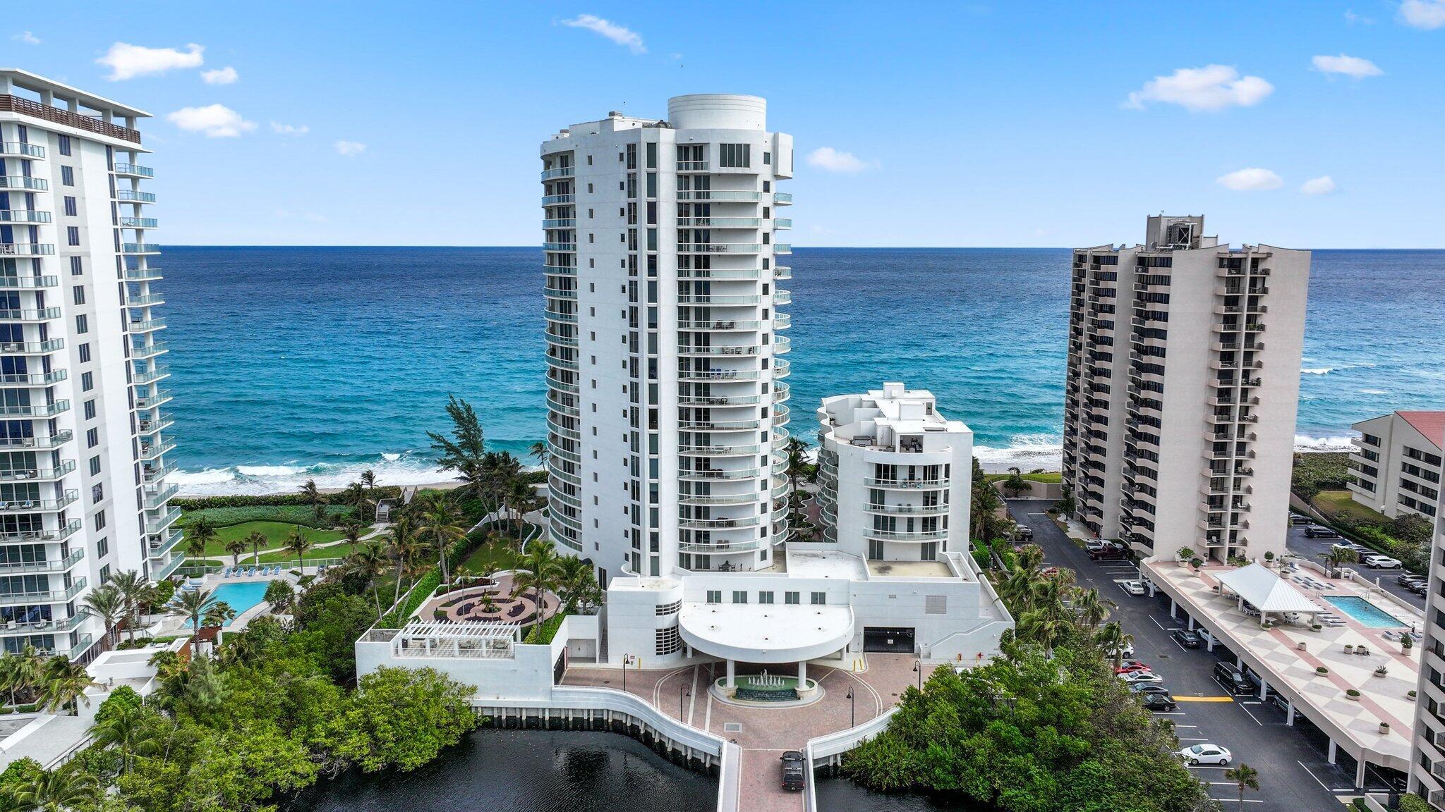 This rare, two-story oceanfront condo offers a unique opportunity to enjoy luxury living directly on the sand of Singer Island. With its own private elevator entry and dedicated foyer, this home blends sophistication and functionality. Soaring 10-foot ceilings and expansive travertine-tiled terraces frame breathtaking ocean views, creating an idyllic retreat.  The upper floor is designed for entertaining and everyday living, featuring an open-concept layout. The gourmet kitchen boasts stainless steel appliances, including a wine cooler and a recently upgraded refrigerator. The adjoining dining area provides an inviting space for gatherings,, perfectly complemented by the stunning views.