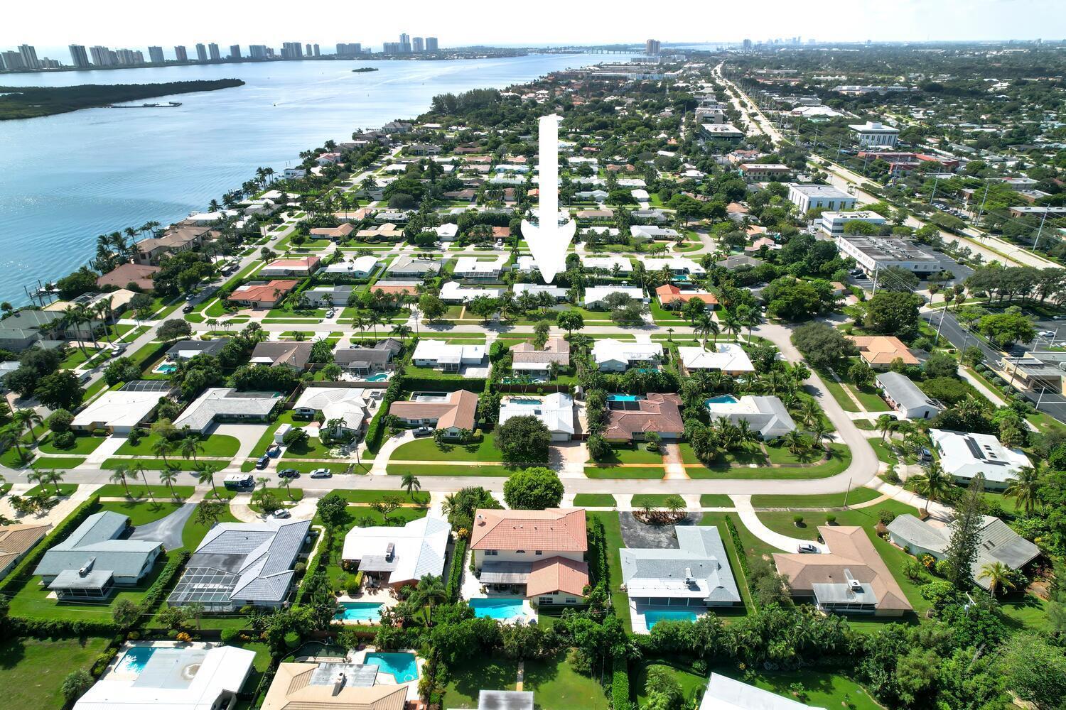 Renovated pool Home in the Yacht Club addition of the Village of North Palm Beach. Welcome to this beautifully renovated 3-bedroom, 2-bath, 2 car garage pool home, perfectly situated east of US-1 in The Village of North Palm Beach . The home features elegant hardwood flooring throughout all living areas,  with a view of the pool and backyard from almost every room.Step into the heart of the home and enjoy the stylish kitchen, which boasts quartz countertops with a full tile backsplash, a counter bar, and stainless steel Viking appliances. The open living spaces are enhanced by recessed lighting and plantation shutters, and lead seamlessly through a  to a  covered lanai--ideal for entertaining or relaxing. The inviting primary bedroom offers an en-suite bath with double sinks and a separate shower. The other two bedrooms are spacious and comfortable, sharing a well-appointed second bath. Outside, the fully fenced yard provides privacy and a perfect setting for the sparkling pool with a spill-over spa. The 2-car garage adds practicality and ample storage. This home combines sophisticated updates with prime location advantages, making it a must-see! Close to the newly renovated North Palm Beach Country Club, recreation, beaches, fine dining, entertainment and shopping. 
Easy access to major highways and Palm Beach International Airport.