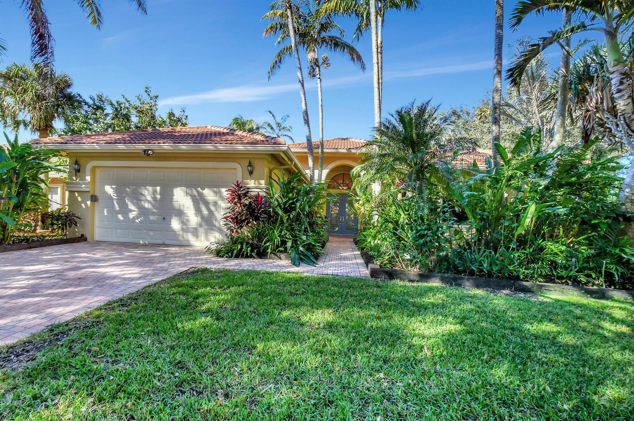 Move-in ready. Roof replaced in 2019. Hurricane shutters throughout. NEW ROOF AND PARADISE? You'll never want to leave this impeccable, move-in ready home. Entertain your family & friends as you stroll through the backyard of lush tropical garden oasis-gorgeous orchids, imported fruit trees: Portuguese grapes, passion, mango & starfruit, spa/jets/air blower dipping pool and outdoor/summer kitchen with stainless appliances. This immaculate home has 3 bedrooms plus den/office and 2. 5 baths, engineered hardwood flooring & tile, fabulous kitchen with stainless appliances overlooking family room, water filtration system, master bedroom has huge walk-in closets with built in drawers, convenient electric Roman shades,  garage tiled flooring and custom cabinets. Very active 55 plus community