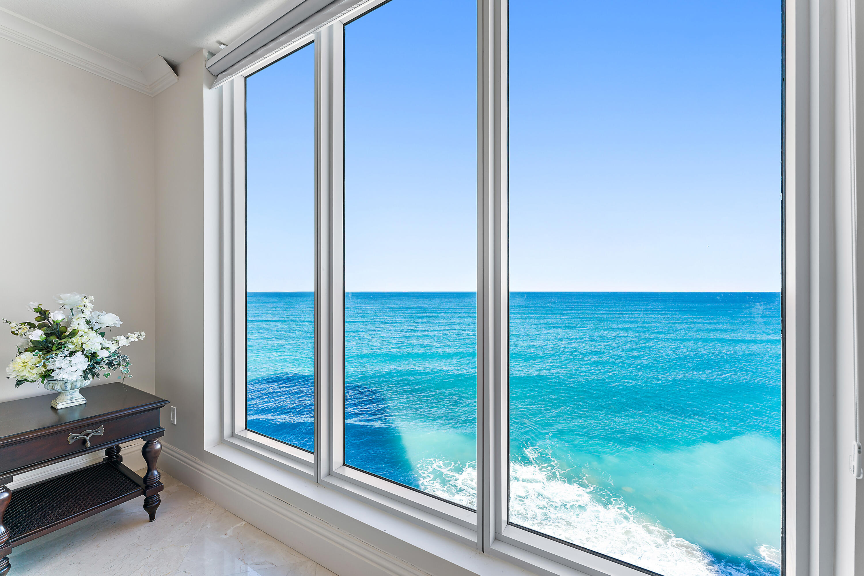 Motivated seller, bring all offers!Discover unparalleled luxury and breathtaking oceanfront living at Ocean's Edge, a privately gated community on Singer Island. Nestled between the sparkling turquoise waters of the Atlantic Ocean and the serene Intracoastal Waterway, this rarely available floor plan lives like a single-family home, offering over 3,100 square feet of living space. Featuring 3 bedrooms, 3.5 baths, a grand open-concept living space and a sprawling oceanfront balcony. Step off the elevator into your private foyer, where floor-to-ceiling windows and sliding glass doors frame spectacular panoramic views of the Atlantic Ocean, the Southeast skyline, and the Intracoastal. The gourmet kitchen is a chef's dream, boasting quartz countertops, a Sub-Zero refrigerator and wine cooler, Miele double ovens and warming drawer, a Wolf five-burner gas cooktop and a built-in Miele coffee maker. The eat-in kitchen flows effortlessly to a formal dining space as well as into the main living areas and exterior space, creating an ideal setting for enjoyment or entertaining.  

The primary suite is a tranquil retreat, featuring direct ocean views, a spa-inspired bath and a custom walk-in closet. Two spacious guest suites have their own bathrooms and beautiful views of the sunset and intracoastal.  An additional powder bath adds function to the space as well as a separate utility room with washer/dryer and extra storage.  

With only 40 exclusive residences, Ocean's Edge offers amenities to include: a heated oceanfront pool and spa, private cabanas, an outdoor grilling area, and a state-of-the-art fitness center. Residents enjoy access to a private movie theater, an elegant social room, and a newly renovated gym and lounge. The 24-hour manned security gate, concierge services, and controlled-access parking provide peace of mind, while a private boardwalk offers direct access to Singer Island's pristine, white sandy beaches.

Singer Island is a haven for outdoor enthusiasts. The island is home to John D. MacArthur Beach State Park, a lush natural preserve perfect for kayaking, paddleboarding, snorkeling, or relaxing on its unspoiled beaches. For golf lovers, championship courses are just minutes away, while the vibrant shopping, dining, and entertainment of Palm Beach Gardens and Worth Avenue are within easy reach.

Conveniently located just a short drive from Palm Beach International Airport, Ocean's Edge combines tropical tranquility with cosmopolitan convenience, offering the ultimate oceanfront lifestyle