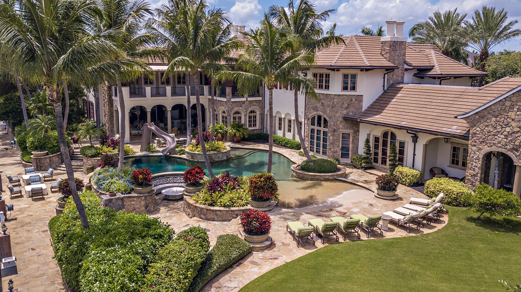 This unprecedented 25-room mansion sits on over one acre with 300 feet of water frontage. This property has been said to be one of the most celebrated estates in the Royal Palm Yacht & Country Club. Luxurious living with over 18,000sf of expansive living areas, formal dining room, temperature-controlled wine cellar, movie theater, game rooms, stunning flagstone terraces, a resort-style pool, and grand entertainment loggia. Perfectly situated on a triple lot complete with 6 car garage and dock.