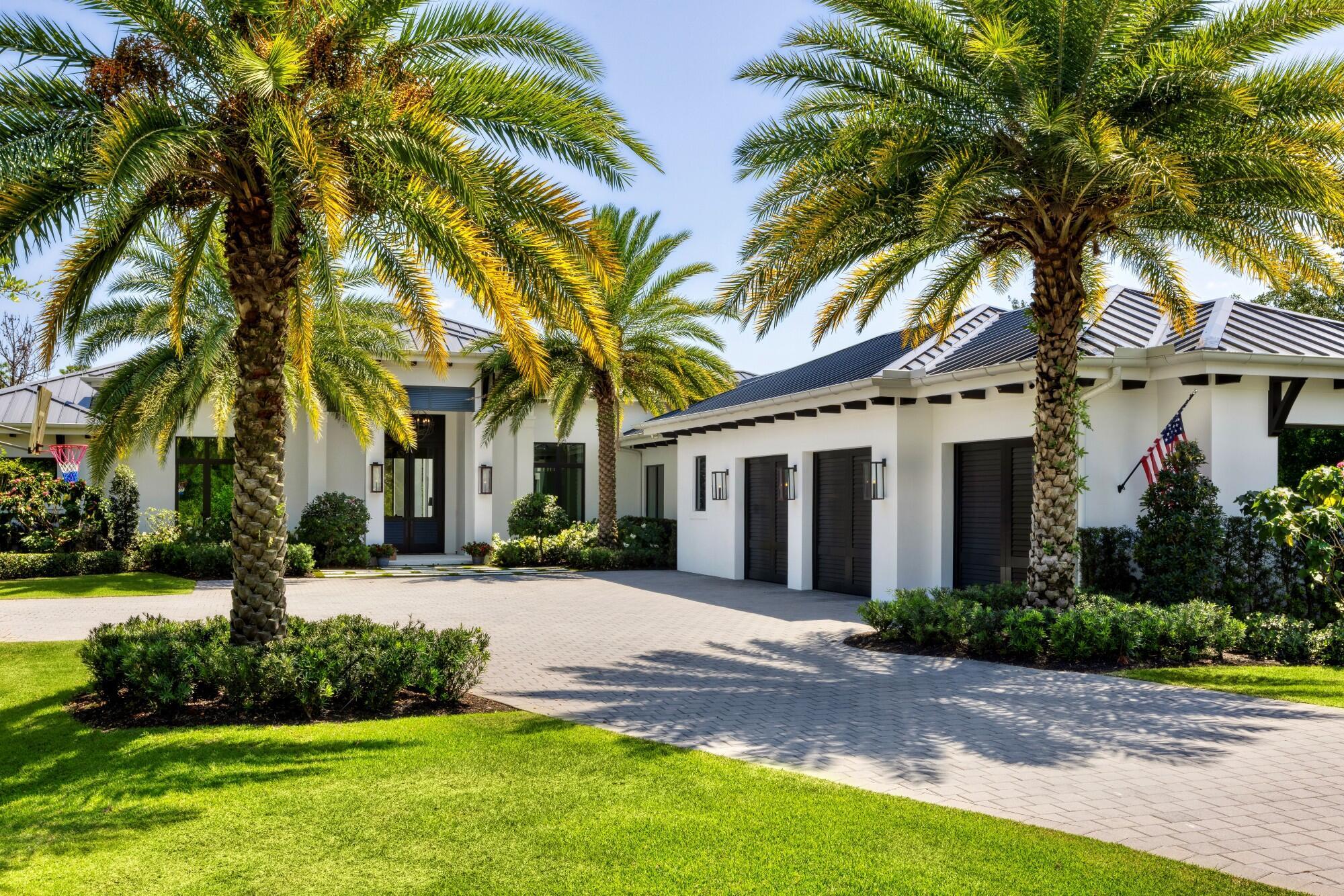 Nestled on a sprawling 1-acre lot in the gated enclave of Hidden Bridge in Jupiter, this magnificent home offers luxury, privacy, and impeccable craftsmanship. Built in 2020 by the renowned Willoughby Construction, no detail was overlooked in creating this exceptional residence. Spanning over 5,000 square feet of refined living space, this home features four spacious bedrooms, each with its own en-suite bathroom, ensuring comfort and privacy for family and guests alike. Additionally, the property includes two elegant half baths, a dedicated office for remote work or quiet study, and a three-car garage designed for both convenience and style. The heart of the home is a stunning open concept living area, where natural light floods through expansive windows, highlighting high-end finishes and thoughtful architectural details. The chef's kitchen, equipped with top-of-the-line appliances and custom cabinetry, flows seamlessly into both formal and casual dining spaces, perfect for entertaining. Step outside to your private oasis: a custom-designed resort-style pool surrounded by lush landscaping, creating a serene and inviting atmosphere. This outdoor space, complete with a covered patio and ample lounging areas, is ideal for both relaxation and hosting gatherings. Hidden Bridge is a unique community with just 16 custom-built estates, offering residents a rare combination of tranquility and exclusivity. Large lots and mature landscaping enhance the sense of privacy, making it one of South Florida's best-kept secrets. Welcome to 7926 SE Hidden Bridge Court&#x14;where luxury living meets peaceful seclusion in the heart of Jupiter.