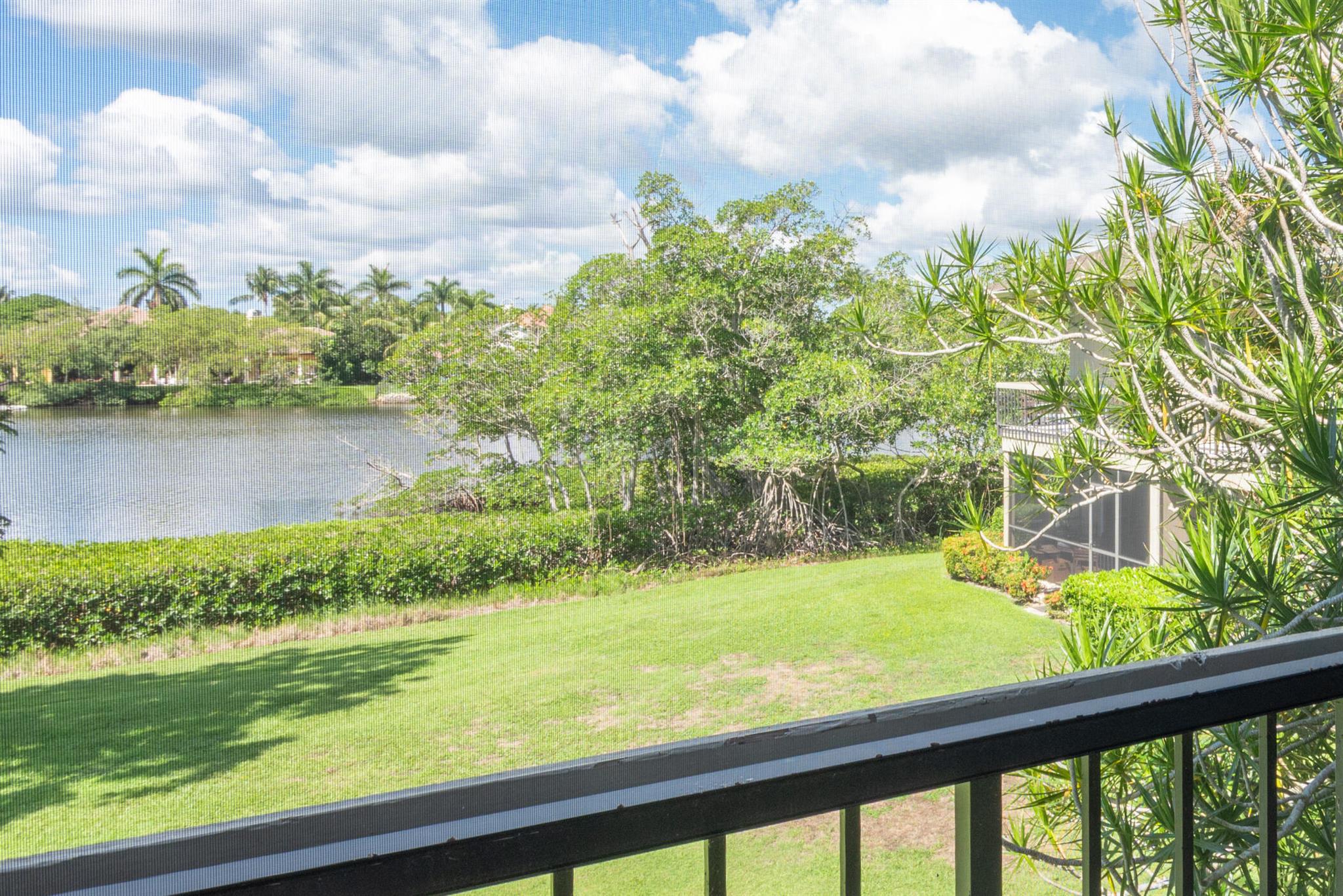 This 1BR, 1.5 Bath has been completely renovated with open concept main living, upgraded SS appliance package, huge granite island, custom wood kitchen cabinetry and large walk in closet.  Impact glass sliding doors on both screened patios overlooking the Loxahatchee River.  Private patio lets you enjoy the green space and the Loxahatchee river activity from the 2nd floor screened large patios. This rare ''end unit'' is without other units on 3 sides which adds to the quiet and comfort.  Porcelain tile throughout, zero grout and easy to maintain.  Enjoy the golf on the Fazio 18 hole course.  No greens fee's!  Tennis, pickleball, clubhouse and loads of green space.  Convenient to airport, shopping, restaurants and boating all close by.