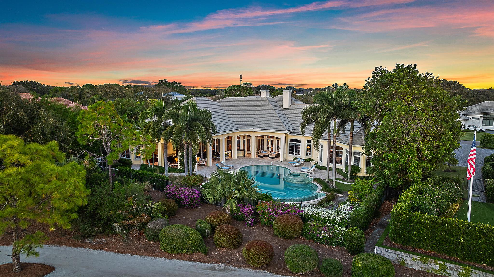 Nestled in the prestigious Jupiter Hills Village, this residence exemplifies the apex of luxury indoor-outdoor living. A custom-built estate, it stands as one of only eleven exclusive homes on the renowned Hills course, a golf course steeped in history, currently ranked 4th in the state and consistently in the Top 100 nationwide for over 3 decades. Designed for seamless entertaining, the outdoor bar and fireplace offer a welcoming retreat for year-round gatherings. Expansive windows and electronic sliding doors blur the boundaries between the family room, kitchen, and outdoor spaces, connecting effortlessly to the fireplace, bar, grill, and poolside terraces. For formal occasions, an elegant dining room, complete with an adjacent wet bar &amp; new 200 bottle wine fridge in the cellar, elevates the experience of entertaining. The owner's wing is a haven of tranquility, featuring a private massage room, his-and-her baths, spacious walk-in closets, and a dedicated laundry room. Following a massage, step directly into the pool or jacuzzi for the ultimate relaxation. The main floor also includes two additional bedroom suites, and a large, beautifully paneled office. 
For extended-stay guests, an upstairs suite offers a bonus room and morning bar, providing a comfortable, private space. With over 7,000 square feet of air-conditioned living space, this residence meets the highest standards for those in search of elegance, functionality, and uncompromising quality.

Exterior highlighted features include; 9 separate electronic roll down screens &amp; shutters, Doors In Motion double quad sliding doors off living/family room, new security system, Air conditioned 3-car garage with extra storage, generator (just serviced) with wifi capability, all impact windows/doors, 1,000 gallon propane tank, full home built-in surround sound, surge protection with lightning rods. 

Interior highlights include; Sub Zero refrigerator, 6-burner cooktop, 5 zone A/C (3 replaced in June of 2024), water purification system for entire home, primary bedroom includes his &amp; her baths &amp; large walk-in closets, dedicated laundry, massage room, &amp; sitting/workout room. 

The exterior of the home boasts exceptional features, including nine electronic roll-down screens and shutters, Doors in Motion double quad sliding doors, a newly installed security system, and an air-conditioned three-car garage with additional storage. A recently serviced generator with WiFi capability, impact-rated windows and doors, a 1,000-gallon propane tank, full-home built-in surround sound, surge protection, and lightning rods further enhance its functionality and security.

Inside, the home features a Sub-Zero refrigerator, Wolf six-burner cooktop, and a five-zone A/C system, with three units replaced in June 2024. A whole-home water purification system ensures convenience, while the primary suite offers his-and-her baths, spacious walk-in closets, a dedicated laundry room, a massage room, and a sitting/workout area.