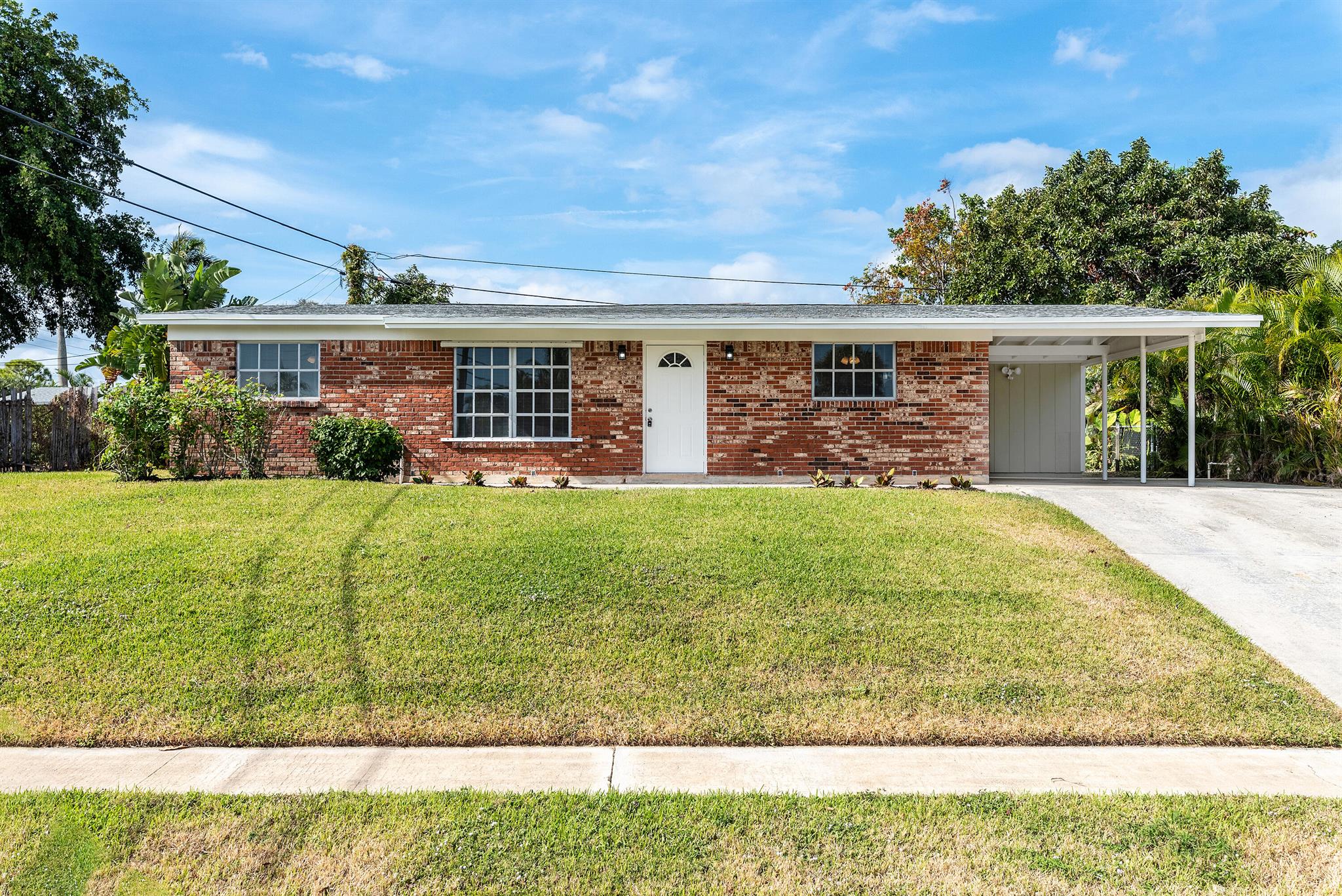 Discover this charming single-family home in the highly desirable Palm Beach Gardens location, just minutes from The Gardens Mall and Downtown at the Gardens! Featuring 3 bedrooms, 2 bathrooms, and over 1,500 sq ft of living space, this property boasts no HOA and offers plenty of updates. Enjoy peace of mind with a new roof and new AC. The updated kitchen showcases granite countertops and stainless steel appliances, complemented by two beautifully updated bathrooms. Stylish new laminate flooring flows throughout the home, and the split floorplan offers privacy. Relax or work in the spacious Florida room, perfect as a den or office. Additional highlights include a workshop with exterior access, a one-car carport, and a fenced backyard with a large storage shed. Set up your showing today!