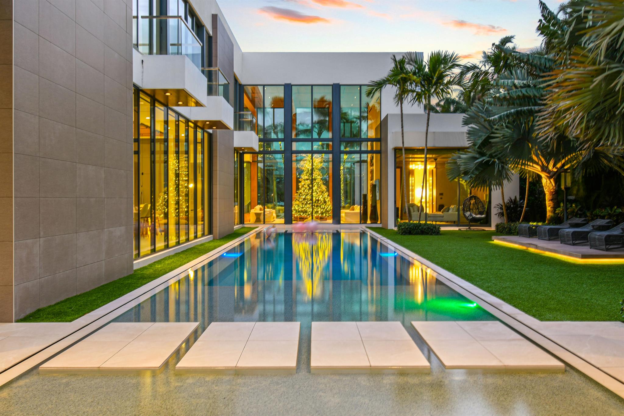 In a league of its own, this architectural masterpiece in Jupiter's prestigious Admirals Cove features sleek modern design, soaring ceilings, and 100 ft of waterfront with no fixed bridges for quick Atlantic access, making it a boater's dream. Highlights include 5 bedrooms, a luxurious first-floor master suite, VIP guest room, a chef's dream kitchen with Italian Valcucine cabinetry, backlit onyx countertops, and Wolf appliances, exquisite wood and stone finishes, a temperature-controlled wine wall, Crestron automation, and elevator. Step out back and be dazzled by the resort-style backyard, complete with a pool, spa, sundeck, summer kitchen, cabana bath, loggia with retractable screens, a private dock, lift and partial Intracoastal views. Offered furnished--when only the best will do. The Club at Admirals Cove is a private community located in Jupiter, Fl, offering a world-class membership experience and an extensive range of Amenities.  Required golf membership purchase conveys all the first-class amenities of Admirals Cove including two clubhouses 45 holes of golf, 5 restaurants, 58 slip marina with floating docks, Yacht Club, 9 har-tru tennis courts,12  pickleball courts, state-of-the-art fitness, physical therapy and wellness, 21,000 sq ft brand new spa &amp; salon.
30 room Waterside Private Boutique Hotel for members and their guests, golf center, coveters kids club, dog park. 
Total convenience at your fingertips.  Close to Palm Beach Airport.