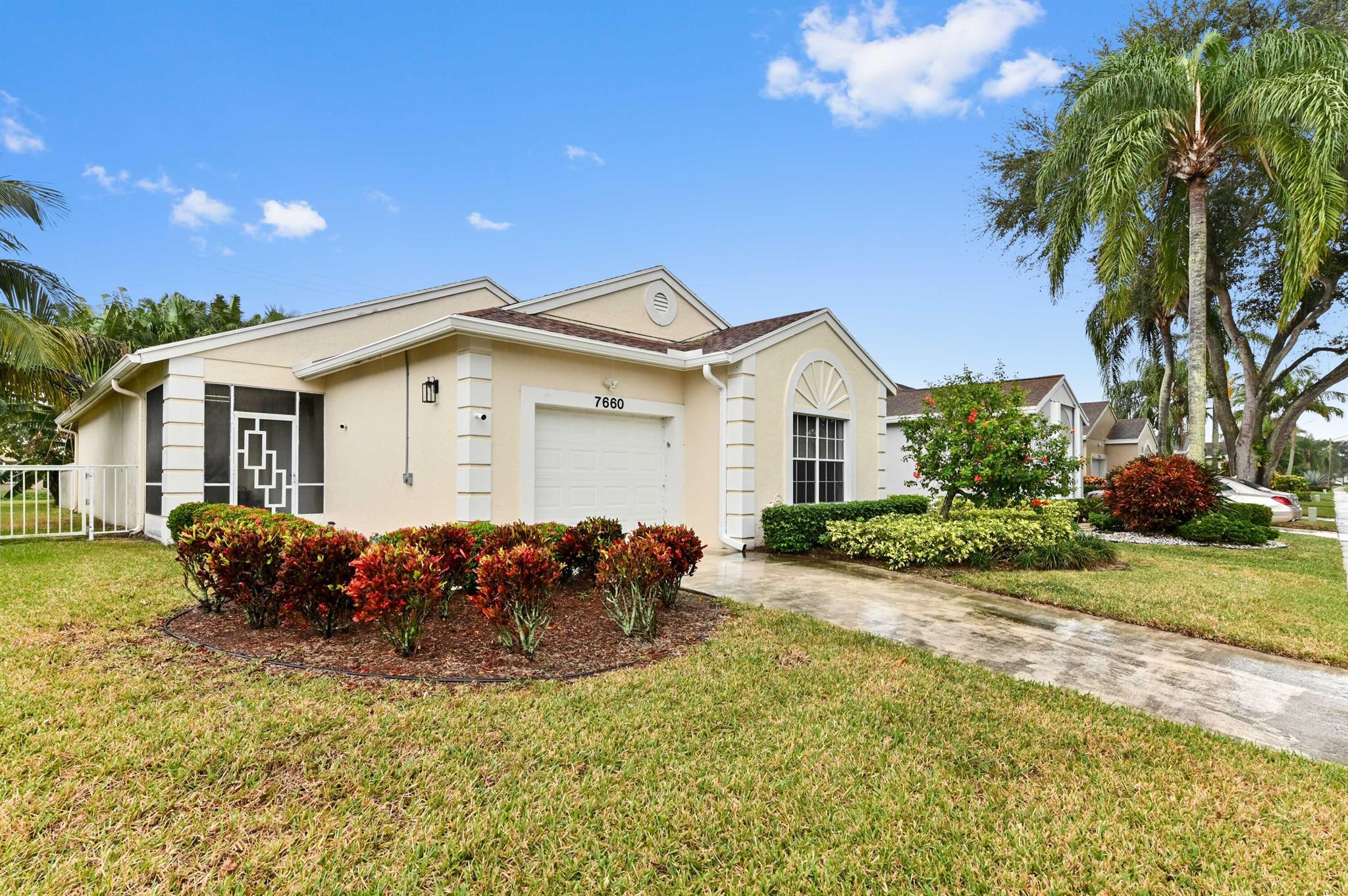 Immerse yourself in the grace and charm radiating from this exemplary single-family home at 7660 Mansfield Hollow Road, set harmoniously within the lively Adult Community of Pine Ridge in sun-drenched Delray Beach, FL. The property's distinguished aura is encapsulated by an inviting covered front porch, a spacious single-car garage, and an elongated driveway for extra convenience.Stepping inside, you will be welcomed by modern tiled flooring throughout the house, save for a cozy carpeted second bedroom. The residence boasts oversized windows peeking from each of the three bedrooms, bathing the spaces with natural illumination for a lively and vibrant feel. With lofty ceilings and an open floor plan, the internal space promotes dynamic adaptability in the heart of your home. 

A stately dining room, commodious living area, and ample family room seamlessly meld together, presenting an ensemble of harmonious living spaces. Meanwhile, the home's kitchen is a joy to behold, complete with a generously sized window, a host of eat-in spaces for cozy family breakfasts, and an overhead skylight to imbue the area with additional brightness.

Continuing the narrative of practicality, a convenient laundry area, outfitted with a full-sized washer and dryer, is ready to cater to your every need. Moving forward, the master bedroom invites serene relaxation with its heart-warming window views, dual walk-in closets for ample storage, and a gracefully stepped-down ensuite bathroom teeming with contemporary luxuries, including a glass-enclosed shower, granite countertop, and dual vanities.

Outside, a capacious screened patio with Plexiglass fittings reveals serene views of an expansive canal. This idyllic outdoor space is a tranquil haven for intimate gatherings and private contemplation, unrestricted by the outdoor elements.

Notable community amenities&#x14;two swimming pools with soothing hot tubs, six pickleball courts, a tennis court, and a shuffleboard court&#x14;further augment this residence's offerings. Services included free alarm monitoring (a Palm Beach County permit is needed), garbage collection, pest control, lawn care, cable TV, and high-speed 300-megabyte internet.

Residents only need to pay the water and electricity charges provided by Palm Beach Water and Florida Power and Light. Nestled within the vibrant Pine Ridge at Delray Beach community, this property presents an unparalleled blend of style, convenience, and plush comfort, beckoning you to make it your cherished home.