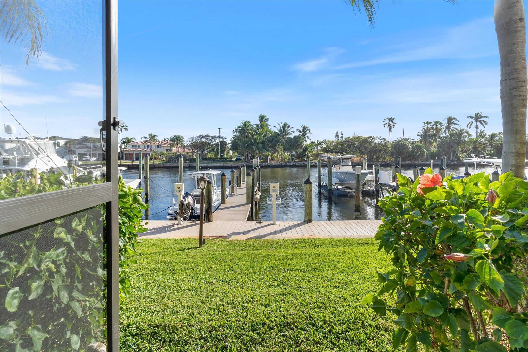 Welcome to your waterfront paradise at Captain's Walk in the sought-after gated community of Pelican Harbor community! This well-maintained property boasts 3 bedrooms, 2 bathrooms with a DEEDED DOCK, and an open-concept layout that is perfect for easy living. This residence features a deeded dock located directly behind the condo, boasting beautiful views and easy access to the boat docks. The dockage provides direct access to the Intracoastal Waterway, and there are no fixed bridges. Whether you're an avid boater or simply enjoy serene water views, this rare feature makes it effortless to indulge in the ultimate Florida lifestyle.

Step inside to discover a light-filled living space with large windows framing picturesque water views. The updated kitchen features modern appliances, granite countertops, and ample cabinetry flowing effortlessly into the dining and living areas. The spacious primary suite includes a large walk-in closet plus a wall closet and en-suite bathroom. Meanwhile, the split floor plan guest rooms offer privacy and comfort for family or visitors.

Additional highlights include:
  * Private screened patio with water views.
  * Assigned covered parking and ample guest spaces.
  * Access to Pelican Harbor's resort-style amenities, including two pools, tennis courts, pickleball and a fitness center.
  * Active Social Committee 

Located just minutes from vibrant Atlantic Avenue, pristine beaches, and premier dining and shopping, this condo combines waterfront living with unbeatable convenience. Whether you're seeking a year-round residence or a seasonal escape, this is your chance to own a slice of coastal heaven.