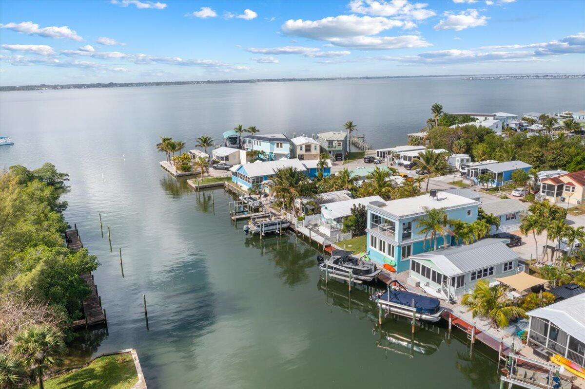 Experience tropical living at its finest in this waterfront oasis, built in 2015. Nestled in the serene Windmill Village, this 2 bedroom, 2.5 bathroom CBS home offers the perfect setting for a vacation retreat, staycation, or year round residence. Enjoy deep water access, breathtaking intracoastal views, and a thoughtfully designed luxury interior. The spacious second-floor outdoor patio is ideal for entertaining or relaxing as you take in the scenery. With impact windows, electronic shutter and a boat lift, this home offers both beauty and peace of mind. Make this tropical paradise your own!