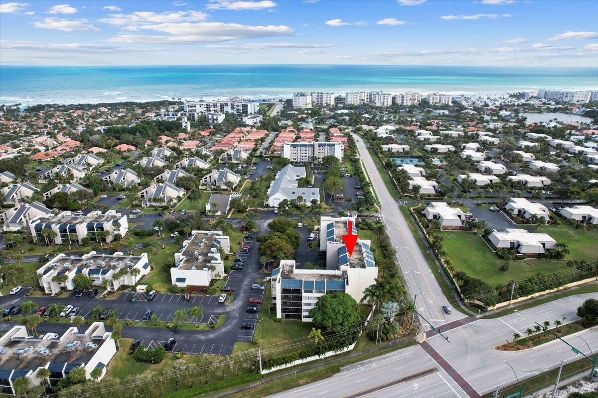 Experience coastal living at Jupiter Ocean & Racquet Club, located steps from Jupiter's picturesque beaches. This spacious 2-bedroom, 2-bathroom condo spans 1500 square feet within a secure building featuring a lobby and elevator. The property boasts a 20-foot screened balcony accessible from both the primary bedroom and the living room, ideal for entertainment and relaxation. The kitchen offers a separate exterior access door and is equipped with stainless steel appliances, replaced in 2019. Additionally, a full-size washer and dryer (2019) enhance daily convenience. Recent upgrades include Impact Windows. There are Accordion Shutters on the sliders, knockdown ceilings, and a newer A/C unit and water heater installed in 2019, housed in a separate outside closet for added interior space.