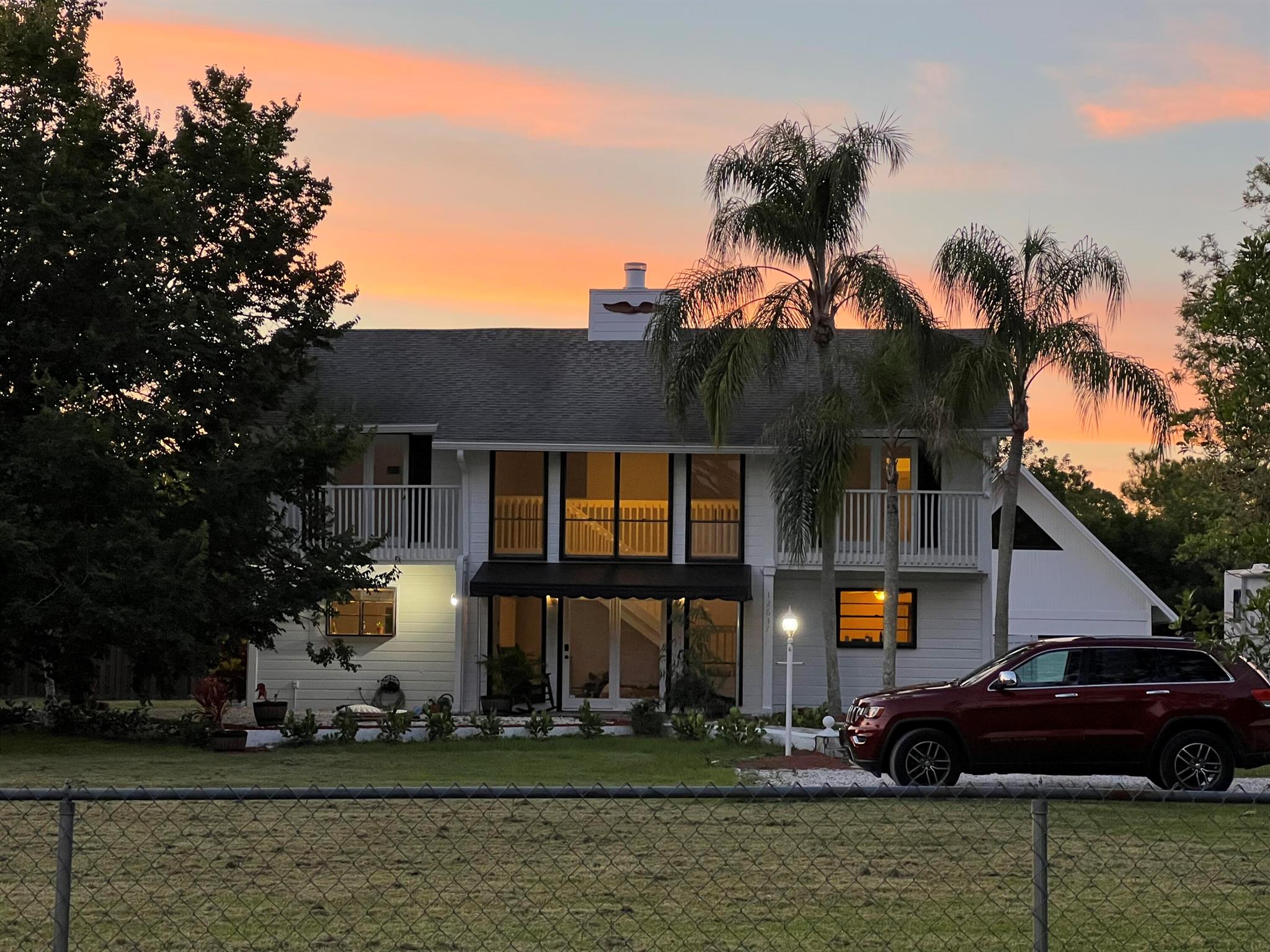 Welcome home to this light and bright spacious 5 bedroom home on 1 acre in desireable Jupiter Farms. Freshly painted, new tile flooring throughout this home is ideal, wet bar, fireplace, Large kitchen, french doors, seperate laundry room, vaulted ceilings and a 2nd story cat walk provides access to 2 addtional bedrooms. Fully fenced, spacious backyard for entertaining complete with patio furniture and bbq grill. Home sweet Home. This home does not have a garage, however, long driveway and additional parking spaces are positioned for residents. Seperate storage area in add'l structure in rear yard.