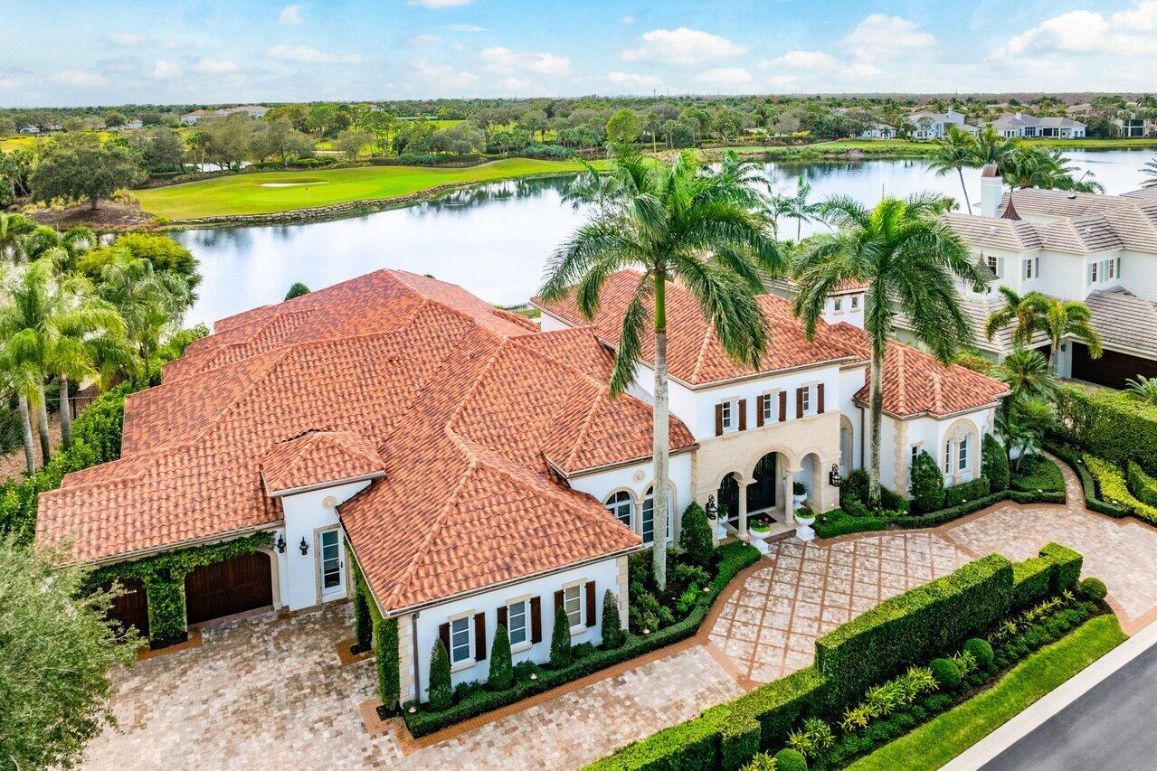 Introducing 108 Via Palacio, a stunning and meticulously maintained estate located in the prestigious Mirasol Country Club community. This impressive home, situated on a spacious 0.46-acre lot offers breathtaking views of water  and the Sunset golf course's 14th hole and features luxurious finishes and upgrades throughout. Boasting 4 bedrooms, 5 full bathrooms, and 2 half bathrooms, this exquisite residence showcases marble, carpet, hardwood, and tile flooring. The gourmet kitchen, renovated in 2023 by Downsview Kitchens, is equipped with top-of-the-line appliances, including a 5-burner induction stove, and a refrigerated wine room with a capacity of approximately 400 bottles. The luxurious primary suite features his and her bathrooms and closets, while the additional bedrooms provide ample space and comfort. A natural gas two-sided fireplace, LED lighting, and Wi-Fi thermostats add to the modern appeal of the home. Enjoy outdoor living at its finest with a beautifully landscaped backyard, offering grass-lined pavers, a beautiful fountain, and a sparkling pool and spa. The summer kitchen, renovated in 2021, and the natural gas pool heater replaced in 2022, make this an ideal space for entertaining. Additional features include a home theater with updated equipment, a whole-house water filtration system, and a whole-house generator powered by natural gas. The property is also equipped with low-voltage LED landscape lighting, impact windows and doors for hurricane protection, and a 3-car garage with space for a golf cart. As part of the Mirasol Country Club community, residents enjoy access to world-class amenities, including two championship golf courses, a state-of-the-art fitness center, spa &amp; salon, 15 har-tru tennis courts, 6 new pickleball courts, children's sports complex and a luxurious clubhouse with four restaurants for a variety of dining options.  The buyers of this home can purchase a highly coveted FULL GOLF membership immediately upon closing or a sports membership if they prefer. Don't miss this opportunity to experience the ultimate in luxury living at 108 Via Palacio. Schedule a private showing today and indulge in the sophistication and grandeur of this extraordinary estate.