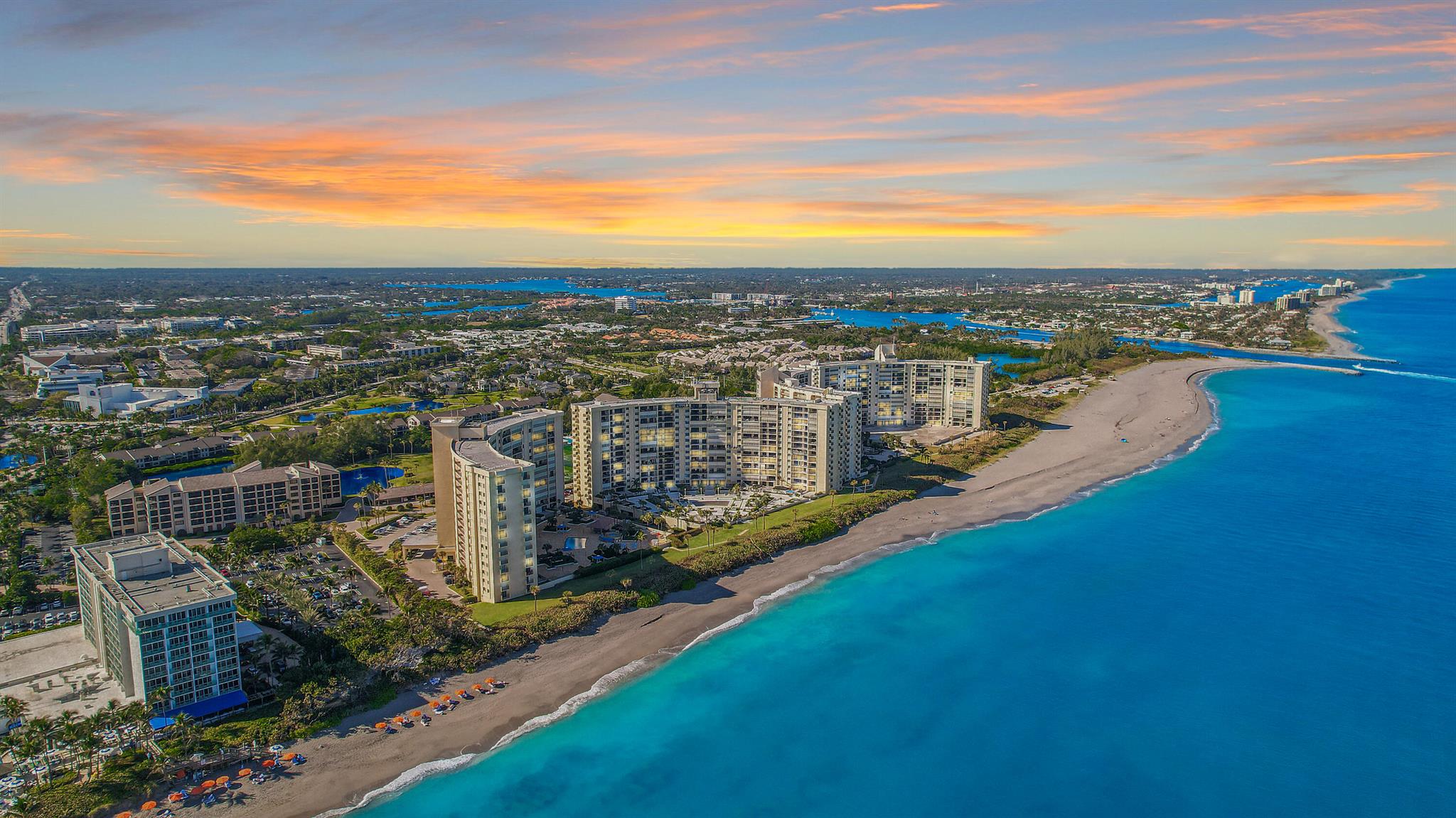 This fully renovated, direct oceanfront condo in Ocean Trail offers stunning panoramic ocean views from every room! The southern most building, it provides private access to the beach and to the Jupiter Beach Resort, offering an unparalleled coastal lifestyle. It features world-class amenities, including nine tennis & pickleball courts, a pool, spa, and a fitness center. The condo itself boasts a modern design with stainless steel appliances, quartz countertops, tiled flooring, and an in-unit w/d. With direct east exposure, you can enjoy breathtaking sunrises right from your living room! The gated community offers underground parking and is close to top restaurants, shopping, & entertainment, this  impeccably maintained condo combines luxury, location, and comfort. Come see for yourself!