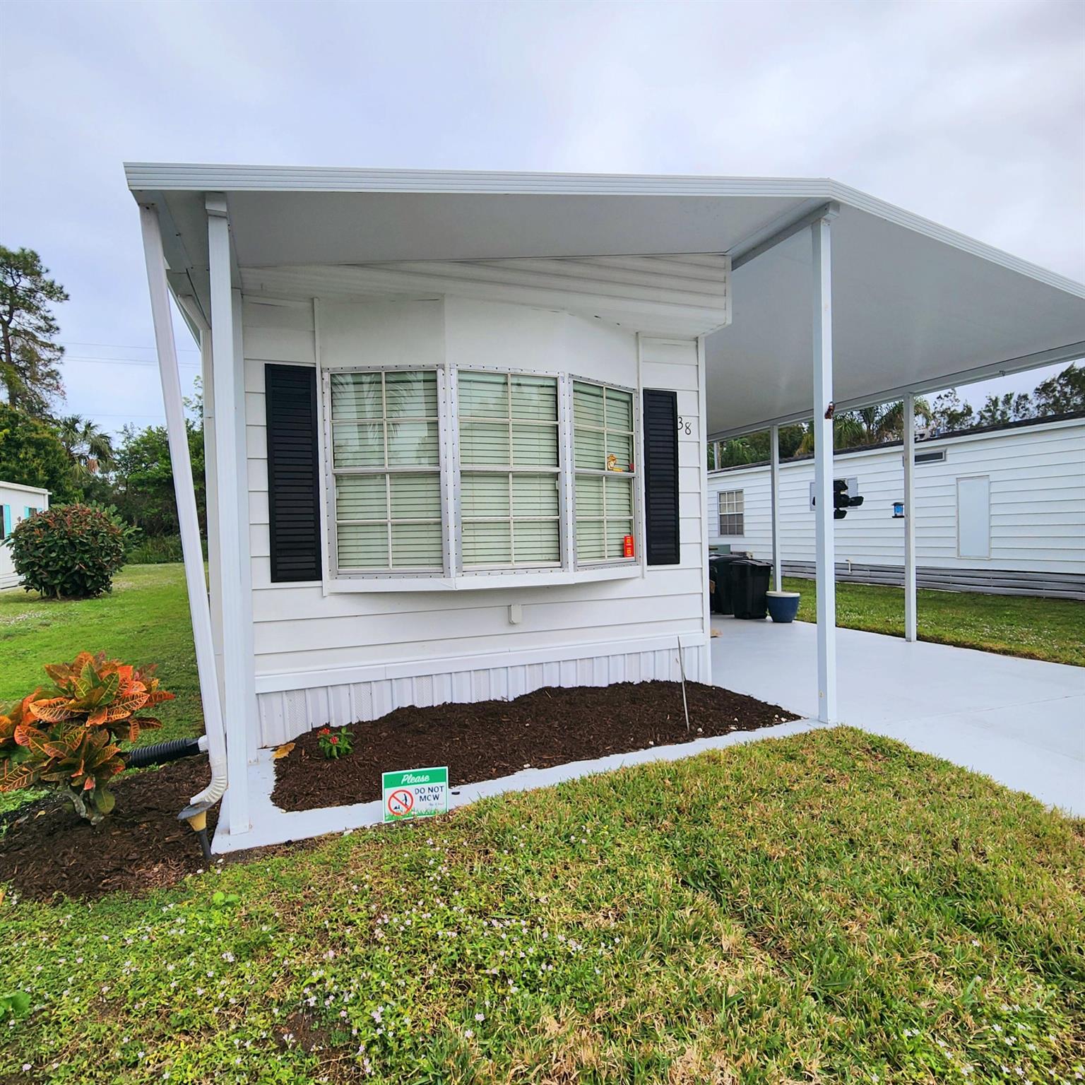 Beautiful, furnished, 2bed 2bath w/ private yard for PETS & more! Yard & patio is perfect for gardening, grilling & relaxing. Remodeled kitchen w/ new appliances! Master bedroom has en-suite bathroom & both bedrooms offer generous closet space. Double anchor tie downs, upgrades, 2024 painted, 2024 AC, 2024 master bed floor & 2024 gutters. Next to a dog walking green & golf course, you'll be pleased w/ this prime location; close to grocery stores, shopping, post office, banks, hospitals & more. Lot lease $823.02 includes lawn care, trash, private golf course (no fees to play), Bingo, swim, pickleball, tennis, shuffleboard, bocce, gym, library, cards, Mahjong, bible study, wood workshop, dinners, parades, dances & more