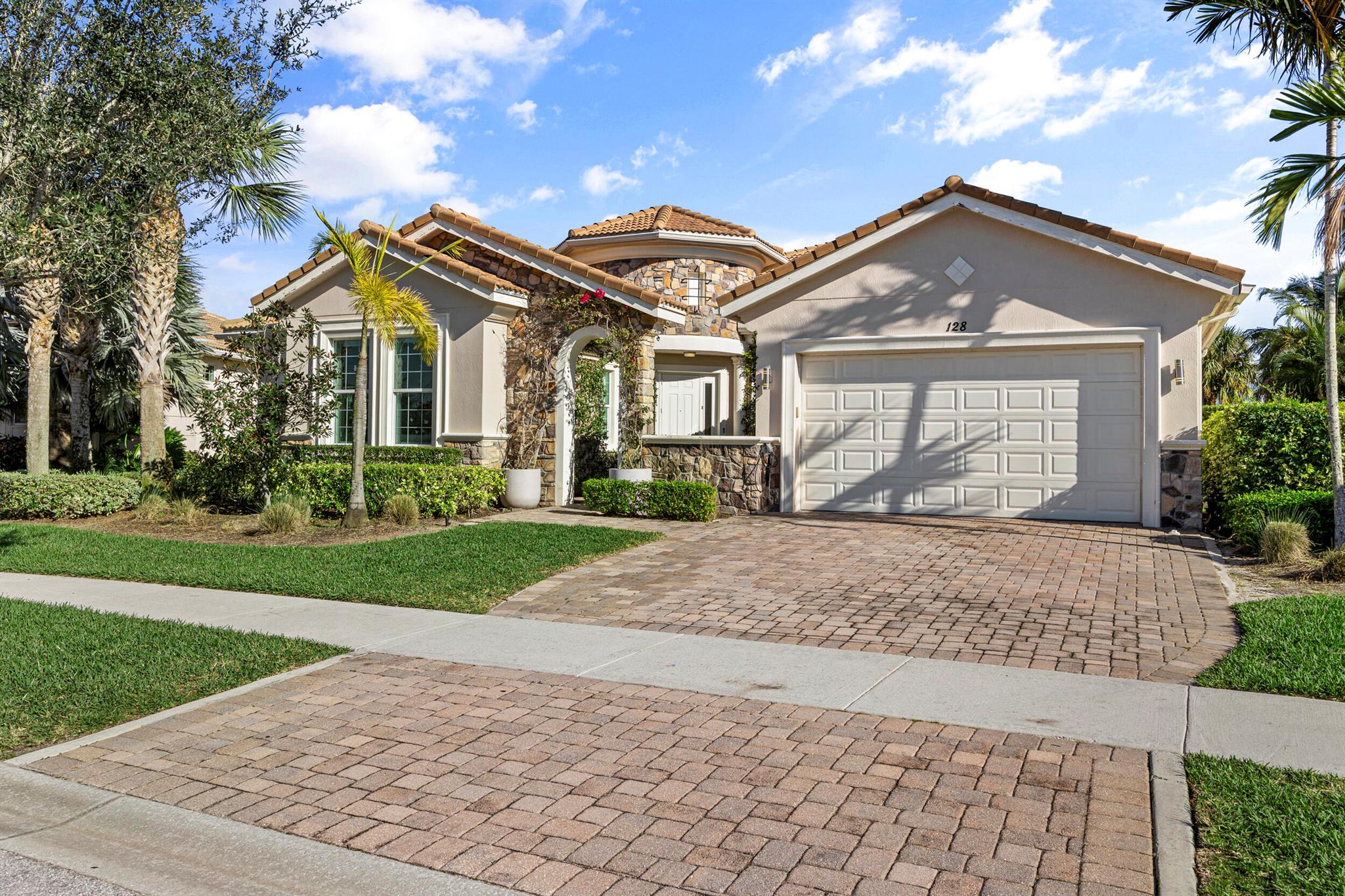 GREAT OPPORTUNITY to own the Largest single level floor plan in Jupiter Country Club's coveted Heritage Estates section! This Renovated 4 bedroom, 3.5 bath home has 3,400 SF of living space + a modern, functional design.  Set between a lake + the golf course, this Solid CBS home offers a tranquil + scenic ambiance.  An outdoor atrium leads to the entry foyer +  a spacious seating area.  The Hub of this home is its family room/kitchen area - spacious and Perfect for gatherings, large or small.  The Chef's kitchen w/ Island features double ovens, a gas range + an oversized fridge!  This light filled area is enhanced by sliders leading to the GORGEOUS outdoor pool + lanai.  Adjacent to the family room is a large 'bonus room', great for a den or home office!   The separate + grand primary BR offers a luxurious + private retreat, enhanced by a large spa bath and generous closet space.  The second bedroom features an ensuite bath and custom closet. Bedrooms 3 and 4 are spacious and share a modern Jack + Jill bath. This home was thoughtfully designed to provide several living + gathering areas, complementing today's lifestyle.  Upgrades include 
-Summer kitchen, 2020
-A/C with UV light, 2023 
-Hot water heater, 2023
-Kitchen pantry, 2023
as well as custom window treatments + electric patio shutters.   
Jupiter Country Club is the Northern Palm Beaches newest Golf + Country Club community, featuring a signature Greg Norman golf course and resort amenities.   All homes are built by Toll Brothers, (voted the nation's #1 home builder) and feature premier Impact windows/doors throughout + natural gas... Energy Efficient!   JCC is located in Jupiter's 'A Rated' school zone.   It is truly an exceptional community with 556 homes + 24 hour manned gated security, all in a picturesque certified Audubon sanctuary.  Located just minutes from the areas finest beaches, shopping, dining, educational + cultural venues as well as the Palm Beach International airport (30 min).   A beautiful lifestyle awaits you!