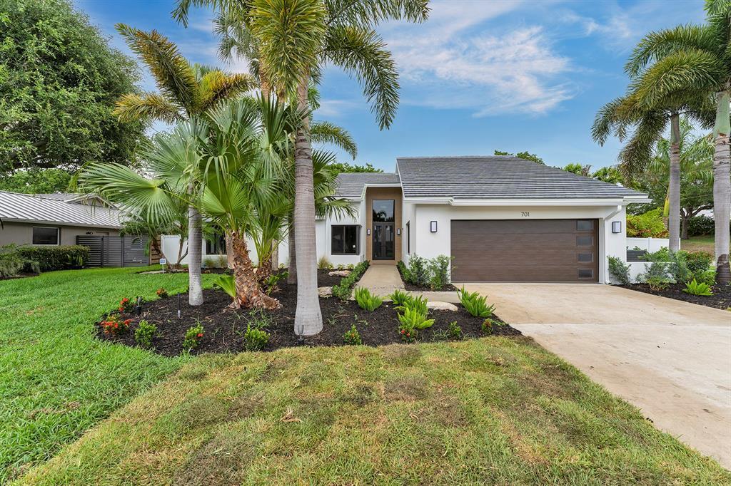 Experience Florida living at its finest! This waterfront home, recently FULLY REMODELED by Tropical Custom Builders, Inc., sits on a corner lot with nearly half an acre of tropical paradise built 16ft above sea level. The renovation includes new flooring throughout, a fully updated kitchen with new Subzero & WOLF appliances, hurricane impact windows & doors throughout, and an updated bathrooms with new shower tiles. The expansive back and side yard is fenced for privacy and features a large pool, covered patio, and a private dock, giving access to fresh water fishing of peacock bass. Located in a non-HOA and pet-friendly neighborhood, it's conveniently close to Bethesda Hospital, beaches, and downtown Delray! PARKING AND SIDE GATE FOR LARGE FISHING BOAT STORAGE.