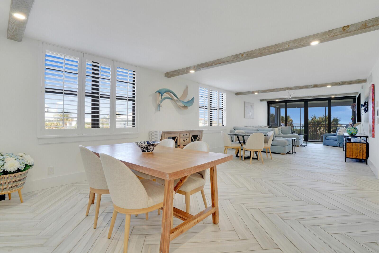 Enjoy endless ocean views from this beautifully renovated 3 bedroom condo in the heart of Juno Beach! Walk to the sand, pier and cafes - no updates needed, just bring your flip flops!This gorgeous coastal retreat offers an unbeatable combination of luxury, space, and location. With expansive ocean views, the open floorplan seamlessly blends modern coastal design with functionality. The custom kitchen is a true showstopper, featuring a massive island, sleek quartz countertops, and stainless steel appliances. Herringbone wood tile flooring flows effortlessly through every room, adding a touch of elegance. Custom closets and meticulously designed bathroom cabinets enhance both style and storage. The bathrooms offer high-end finishes, including frameless shower doors.
