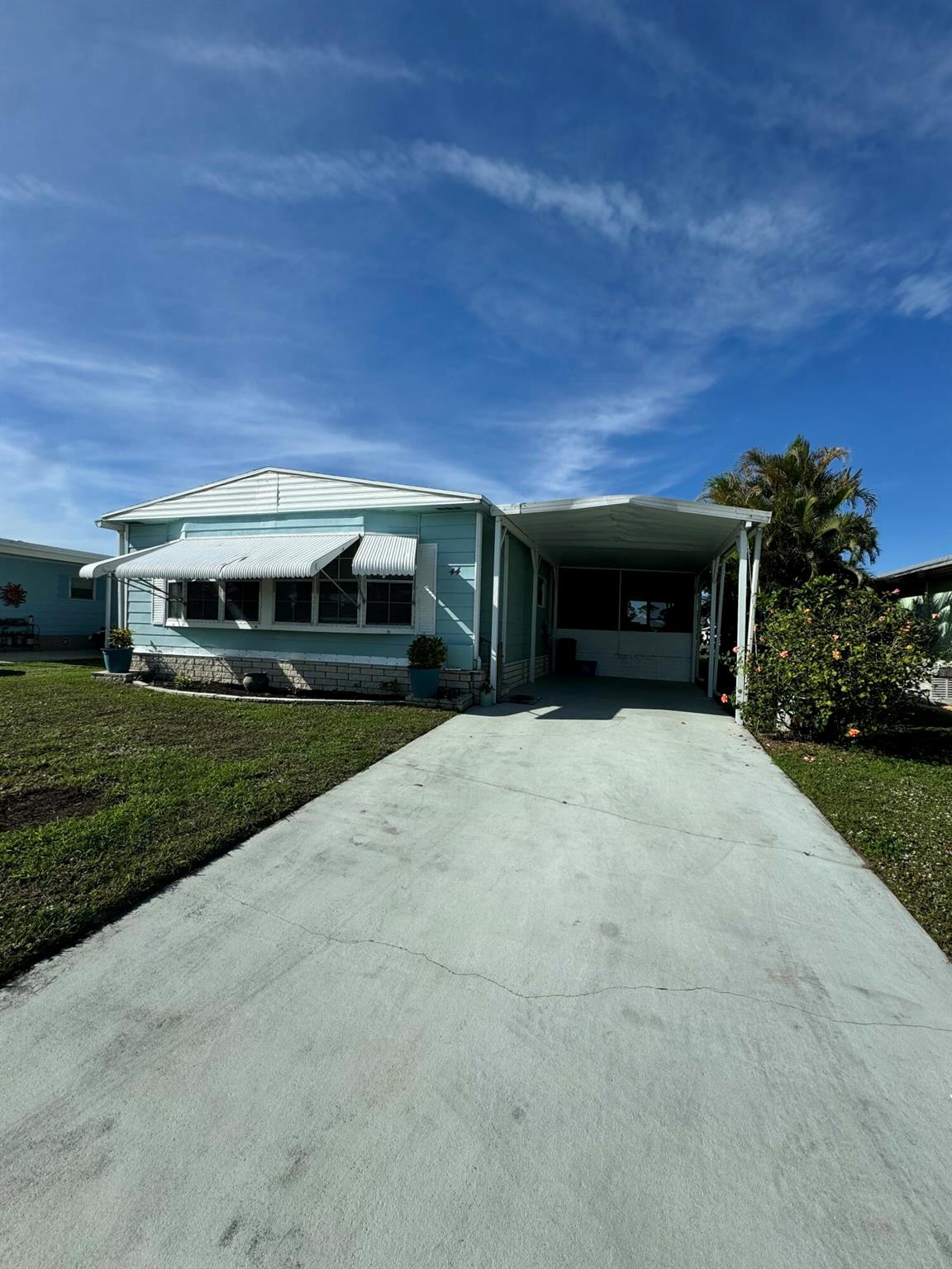 Must see this lovely 2 bedroom 2 bath lake view home. Partial furnished. Laminate floors in every room except guest room. Laundry room inside home with sink and cabinets. New vanity and toilets in bathrooms. Roof is new 2024 and A/C is 2020. Water view in primary bedroom. Walk in closet. Home has lovely screened in room to enjoy morning coffee or evening cocktail looking at lake. Outside patio sitting as well. home is nicely landscaped. Spanish Lakes 55+ community. Lawn care and trash removal included in lot rent. 2 pools, tennis, pickleball, bocceball, shuffle board. club house and much more.