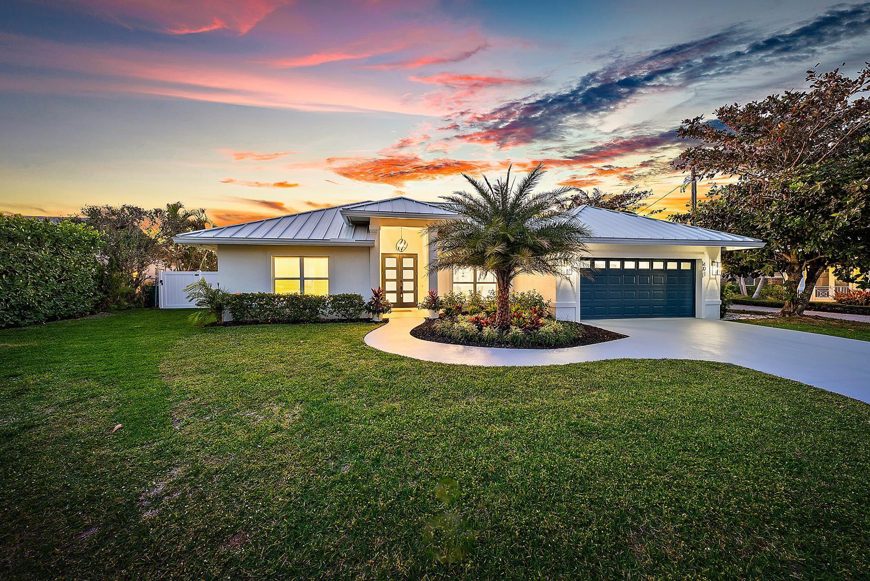 STUNNINGLY REDESIGNED, TOTALLY REMODELED FULLY FURNISHED AND COASTAL CONTEMPORARY INSPIRED BEACH HOUSE IN COVETED JUNO BEACH. THIS BEAUTIFUL HOME'S TRANSFORMATION WAS METICULOUSLY THOUGHT OUT FOR TODAY'S WAY OF BEACH AND ENTERTAINING LIVING. WALLS WERE REMOVED TO OPEN THE SPACE TO GIVE THE FEELING OF SPACIOUSNESS AND INCLUSION WITH THE BRAND NEW DESIGNER KITCHEN WITH EXPANSIVE ISLAND AND TOTALLY NEW BAR AREA WITH CUSTOM CABINETRY. THE NEW DESIGN ALLOWS FOR A WONDERFUL SITTING ROOM OR BREAKFAST AREA THAT OPENS TO THE COVERED PATIO. AS YOU WALK INTO THE PRIMARY SUITE YOU ARE WELCOMED TO HIGH CEILINGS WITH BEAUTIFUL SHIP LAP AND A SPA LIKE BATH WITH A REDESIGNED LARGER CLOSET, DESIGNED VANITY AND AMAZING SHOWER AND STAND ALONE TUB SUITE. IN ADDITION, THIS LUXURIOUS BATH DOUBLES AS A  CABANA BATH OR RETREAT.A WHOLE NEW GUEST SUITE AND BEAUTIFUL FULL BATH WITH OVERSIZED SHOWER AND STUNNING TILE WORK WAS ADDED. MAIN GUEST SUITE SIZE INCREASED AND BATHROOM REDESIGNED TO INCLUDE ADDITIONAL STORAGE AND FUNCTIONS AS A CABANA BATH FOR ADDED EASE OF LIVING WHEN ENJOYING THE POOL AND BACKYARD. IN ADDITION, A MODERN LAUNDRY ROOM WITH FULL SIZE FRONT LOADING WASHER/DRYER WITH A SPACIOUS COUNTERTOP.  THE LIVING ROOM WAS REIMAGINED WITH FULL SLIDERS THAT INVITE YOU DIRECTLY TO THE NEW CUSTOM HEATED POOL WITH ELEGANT TILED ACCENT WALL AND SPECTACULAR WATERFALL FEATURE. THE WHOLE BACKYARD WAS REWORKED TO GAIN CONSIDERABLE YARD SPACE FOR DOG LOVERS, FAMILIES AND SPORTS. PLENTY OF ROOM FOR YOUR CARS WITH A GARAGE AND AMPLE DRIVEWAY. ALL OF THIS A BLOCK FROM ONE OF THE MOST AMAZING STRETCHES OF QUIET BEACHES AND A WONDERFUL LAKE FOR YOUR DAILY WALKS. WALK TO RESTAURANTS AND SHOPS AND EXPERIENCE ALL JUNO BEACH HAS TO OFFER. BRING YOUR TOOTHBRUSH AND ENJOY STRESS FREE LIVING