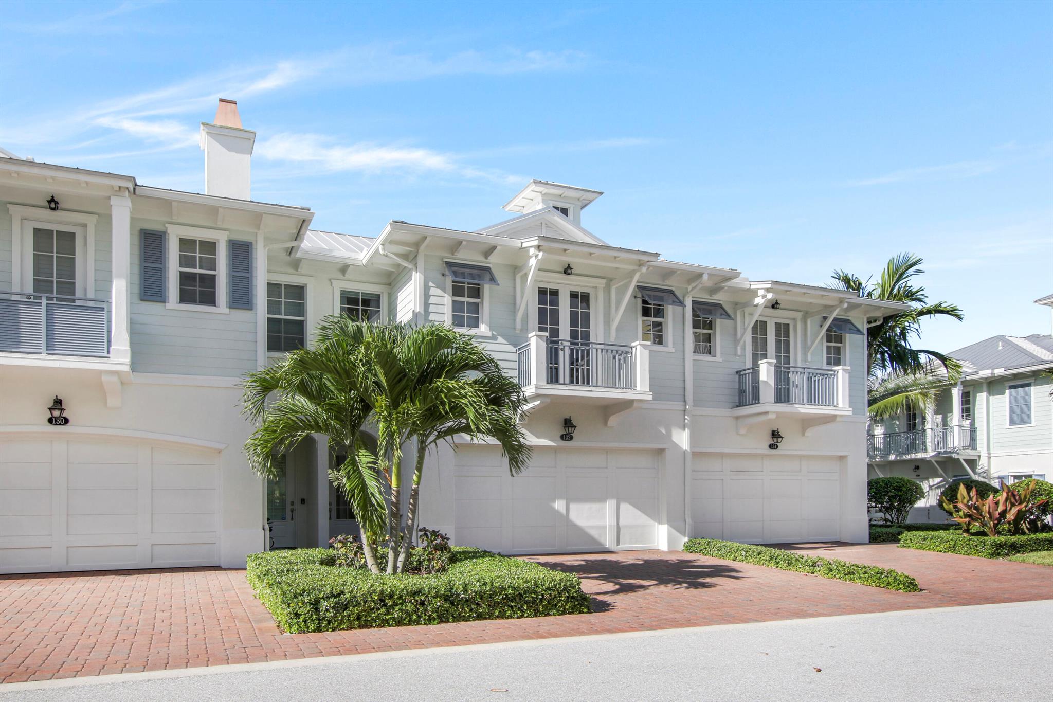 WALK TO THE BEACH! Like new Ocean Breeze townhome rental in Juno Beach. 3 bedrooms, 2.5 baths & a 2 car garage. This townhome is well appointed with stainless steel appliances, quartz countertops, upgraded cabinets & a huge center island. Tile & wood flooring in the entire townhome, crown molding, updated lighting, living/dining & (no carpet at all), a built in desk area & a first floor half bath, 3 bedrooms on the second floor plus the laundry room with full size washer and dryer. The oversized owners suite includes 2 walk in closets and a private balcony and the master bath has a large shower enclosure and dual sinks. The secondary bathroom has shower/tub enclosure. The exterior rear yard includes all synthetic turf. This immaculate townhome is a must see.