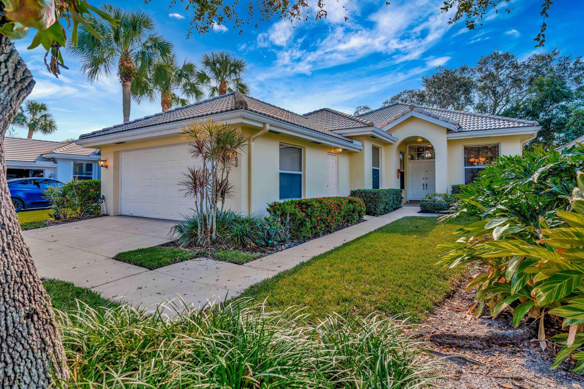 This stunning DiVosta single family home is now available in the Hamptons at Maplewood in Jupiter. This home has been completely redone offering all tile throughout, crown molding, 10 foot ceilings, tastefully decorated and painted in neutral light colors. The kitchen is open to the living area and has a breakfast nook. Custom wood cabinets, quartz counters, upgraded stainless steel appliances, and a unique backsplash all compliment the kitchen. The bathrooms are striking and enhanced with natural light from the skylights. No polybutylene plumbing. The barrel tile roofing was replaced in 2014 along with new skylights, and the 16 SEER AC with smart thermostat was installed in 2019. In addition, PGT impact sliders were installed at the back patio in 2019.