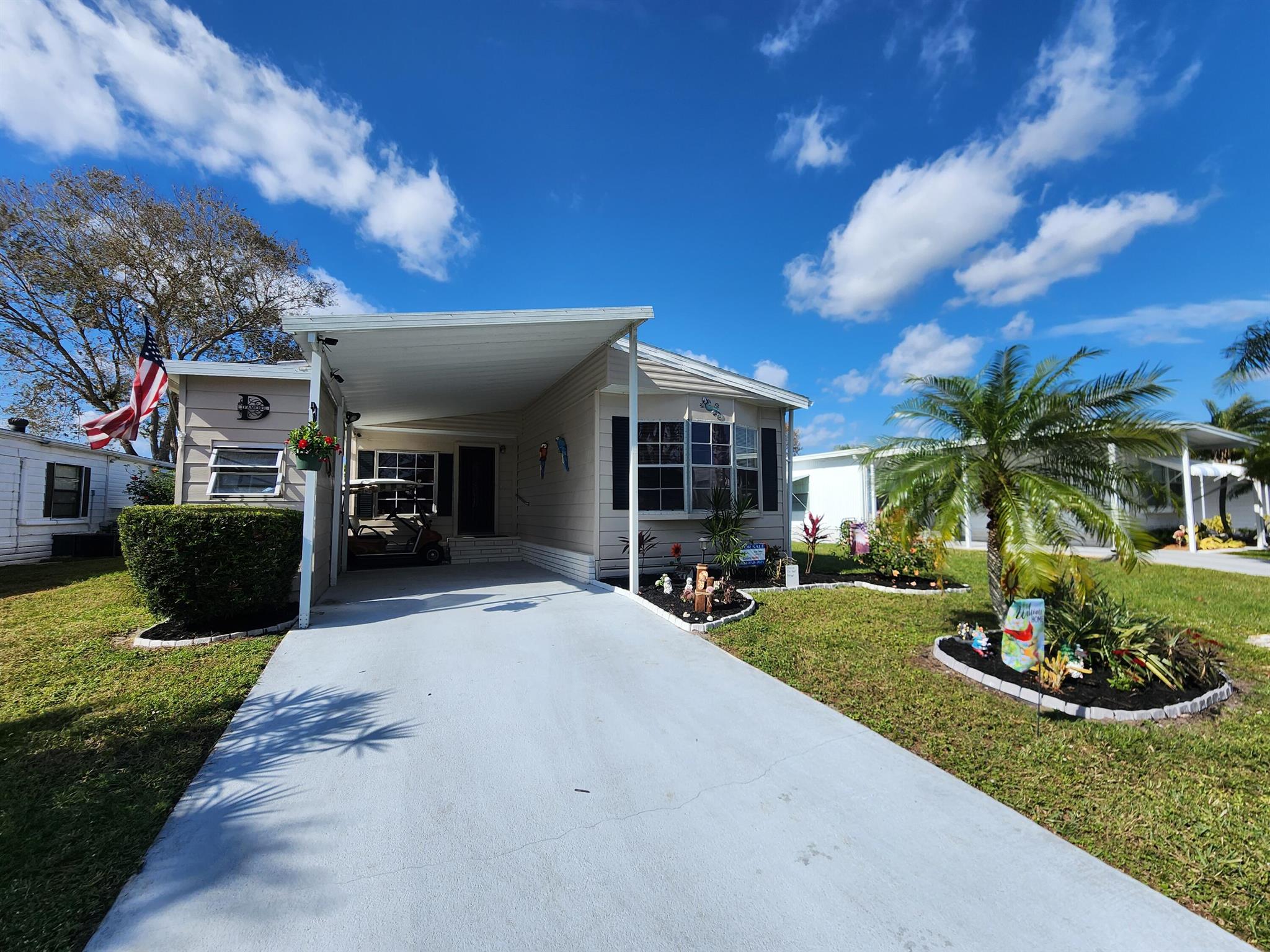 First month FREE LOT RENT comes w/ this 2 Bed/2 Bath home. Dont hesitate to own a fully furnished, turnkey home in a vibrant 55+ community! Well-maintained! Updates; 2019 ROOF, 2018 AC, 2023 VENTS, 2025 POWER WASHED & PAINTED DRIVEWAY, & Kitchen FLOOR REPLACED! Beautifully designed & nestled in a warm, welcoming neighborhood, this home offers more than a place to live - it's a true community. Neighbors are like family, hosting parades, dances & dinners while always looking out for one another. Enjoy a close-knit street where friendships flourish & social events unite.PRIME location; 15 min to beach but NO FLOOD ZONE, close to grocery, bank,pharmacy,grocery,postal,& more! Lot lease  includes lawn care, trash,free private golf course,heated pool,gym,cards,pickleball, tennis, bocce & more!