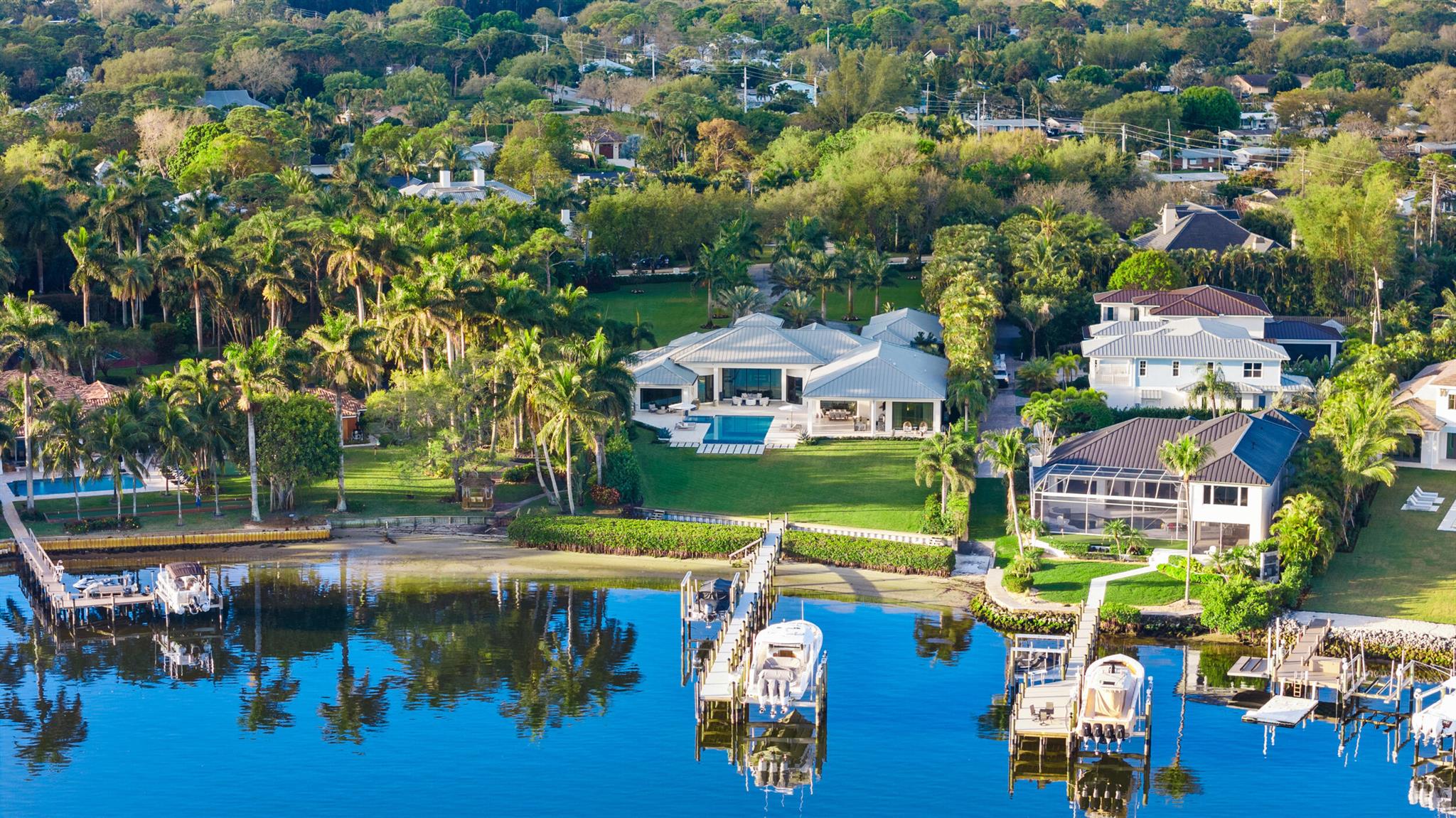 Located on the scenic and wild Loxahatchee River, this estate has 5bd, 6bth, 4 car garage. Just under 1.7 acres, the property is privately gated and offers total privacy. Completely renovated, concrete construction, impact glass and whole house generator. Multiple boating options including a new 50k lb lift. Single story home offers a serene lifestyle with huge river views in the most convenient location. Much desired 4 car garage and room to build additional garages/guest house etc. boating, fishing, water skiing even room for a tennis court. Location is special with easy access to shopping, restaurants, golf courses etc. minutes away from I95 and Floridas Turnpike with quick public and private airport access. Whole house generator and immaculate!