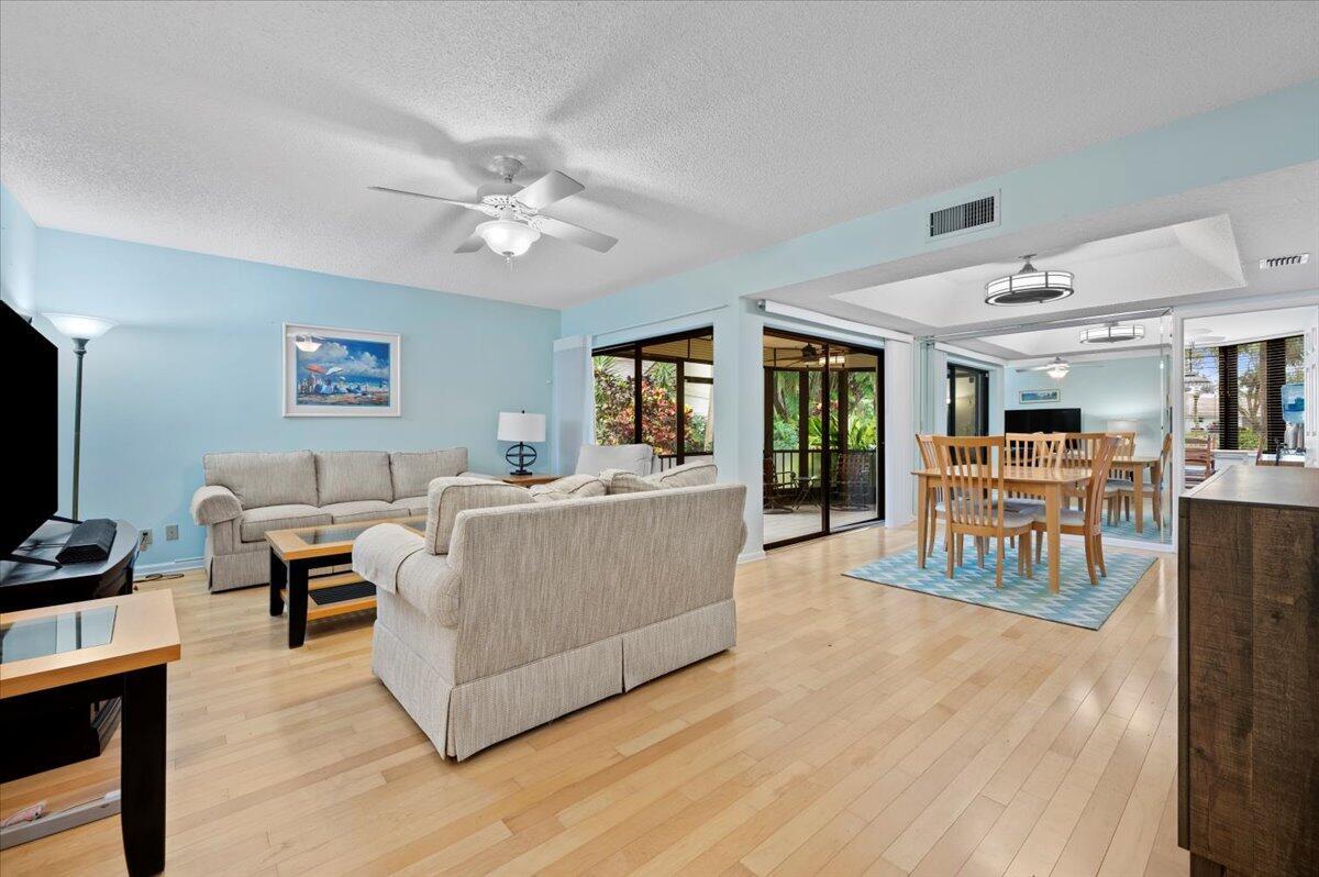 Welcome to your dream home at 16942 Waterbend Drive, Unit 155, nestled in the beautiful golf course community of Jonathan's Landing in Jupiter, FL! This ground floor end unit offers a stunning view of the 10th hole, making it a golfer's paradise.With 1,494 square feet of living space, this condo features 2 cozy bedrooms and 2 well-appointed bathrooms. The open layout and elegant tray ceiling create a spacious and inviting atmosphere. Step out onto the tiled screened porch, complete with roll-down shutters, and enjoy the serene golf course views.This home comes with a one-car garage and a separate storage area perfect for your golf cart, making it easy to explore the community. The amenities here are second to none, with a security guard for added peace of mind. The community offers a public marina for boating enthusiasts, with boat storage available. Please note that availability and pricing for these services are not included. Residents can enjoy access to a clubhouse and pool, with golf and tennis memberships available for purchase for those who love to stay active. Dining options are just steps away, with two on-site restaurants to choose from.

Whether you're an avid golfer or simply looking for a tranquil retreat, this home offers the perfect lifestyle. Come see why this property is the ideal place to call home!