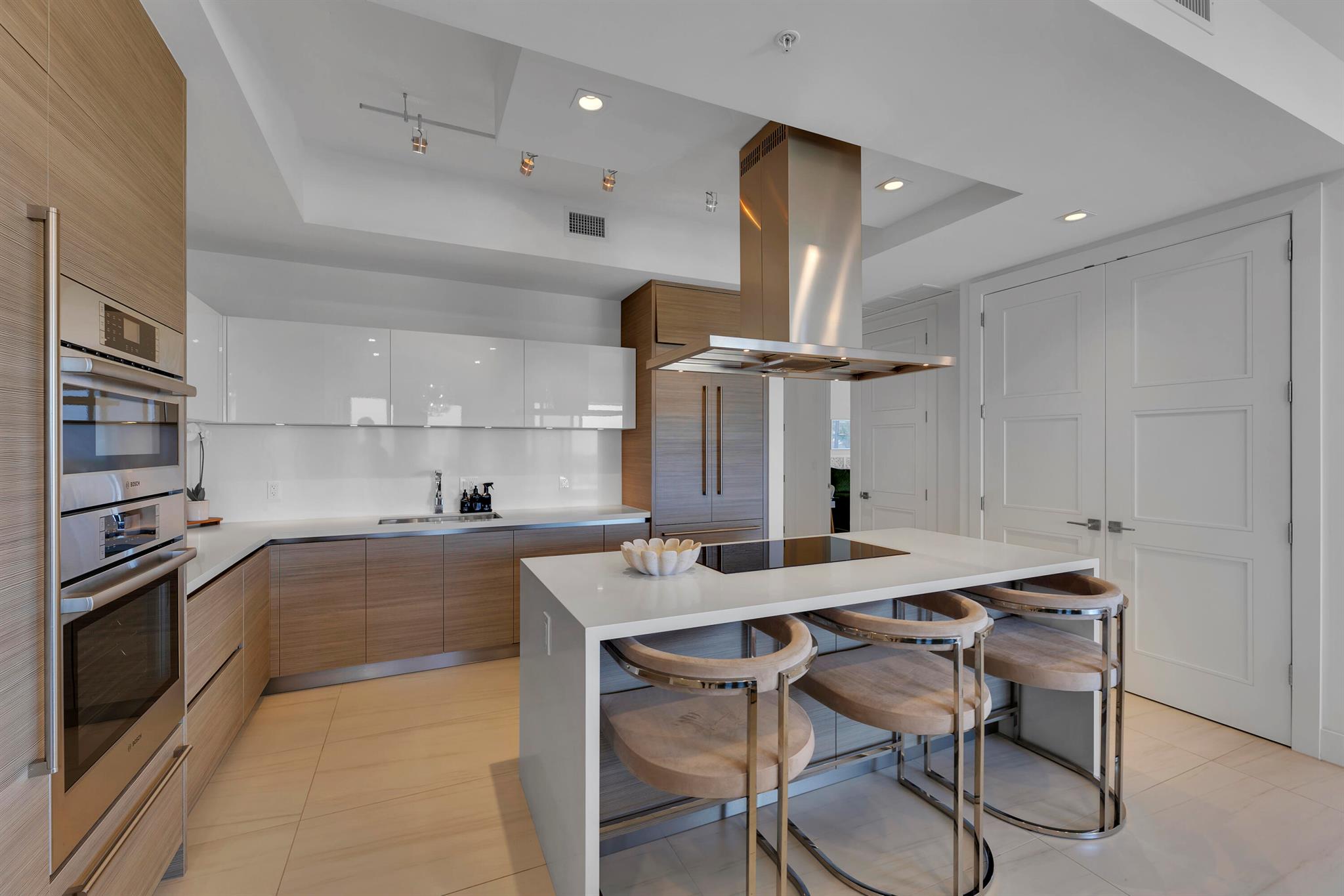 This stunning 6th-floor corner residence offers expansive Eastern views and an open-concept floor plan with luxurious custom upgrades. The chef's kitchen is equipped with Italian cabinetry, top-tier appliances, and sophisticated dropdown lighting. The home features 10-foot ceilings, motorized shades, and custom-built closets throughout. The oversized master suite boasts custom lighting, a large walk-in closet, and a spa-inspired bathroom with a soaking tub & separate shower. A spacious balcony runs along the entire east side. This unit also includes 2 gated garage spaces and on-site A/C storage. Tower 155 offers resort-style amenities, including a 24-hour concierge, valet, pool, gym, and sauna. Located steps from Mizner Park, dining, shopping, & cultural attractions in downtown Boca Raton