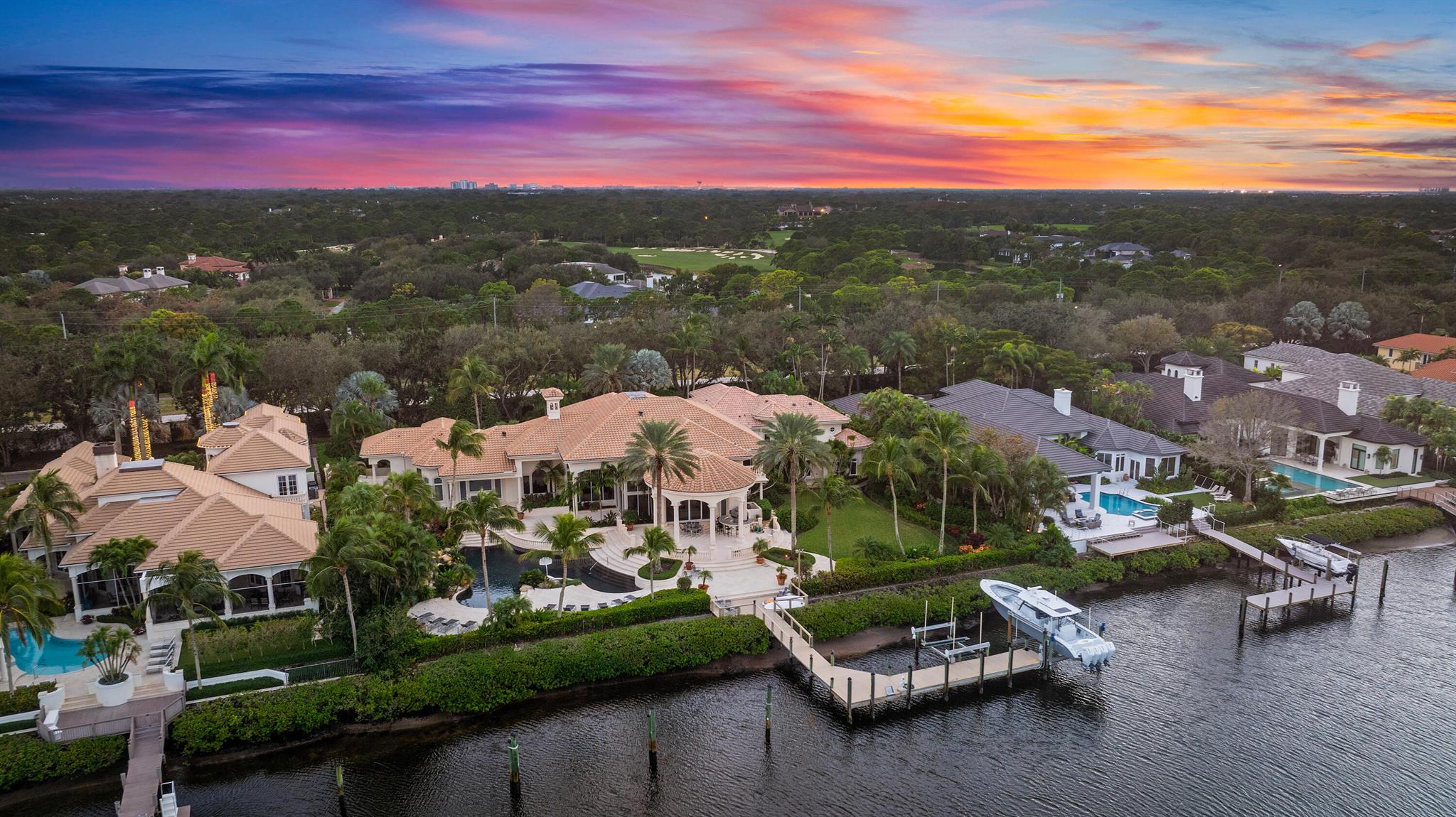 Discover a unique DOUBLE LOT opportunity in the prestigious Admirals Cove Country Club with this expansive .95-acre property, featuring a residence of approximately 9,316 sq. ft. of living space and 12,022 total sq. ft. This stunning estate boasts very high ceilings, an oversized yard with a sparkling pool, and water views. The home also includes a dedicated office, a media room, and numerous spaces designed for luxurious living and entertaining. The property offers approximately 200 linear feet of waterfrontage, with potential to accommodate a yacht over 100 feet (subject to navigability and all applicable requirements). The lot's size and configuration may provide the possibility of dividing it into two parcels of approximately .47 acres each, or for building a new home. Based on certain guidelines, this could allow for a one-story home of up to 14,484 sq. ft. or a two-story home of up to 18,804 sq. ft. at a 5.5 cubic content ratio (subject to all applicable approvals, requirements, and verification). Buyers are encouraged to confirm all measurements, specifications, and potential uses.