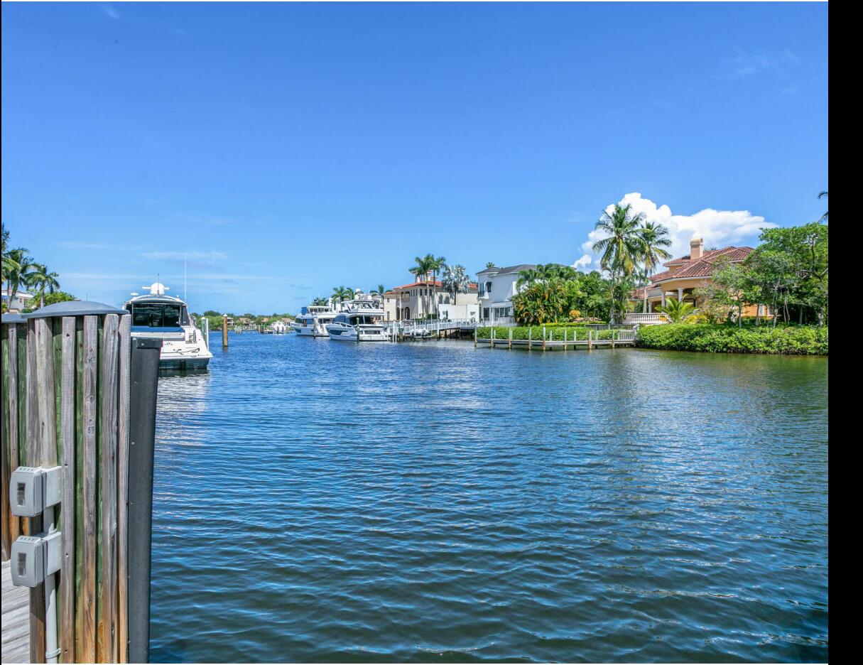 Bring your yacht and water toys. Enjoy the lifestyle at Admirals Cove on one of the best locations. Premier  lot angled to the intracoastal but protected in safe harbor.  Enjoy this one story 4BR/4 1//2 BA home or build or expand on this rarely available location. Presently Coastal Bermuda flair. New Roof. Floor to ceiling impact  windows/doors. Volume Ceilings. Desirable southern expansive water views.  126 ft water frontage for large yacht.  22,000 lb boat lift.  Light and bright sleek kitchen. Media room w/fireplace. Lush tropical landscaping. Expansive outdoor entertaining areas surround resort style pool/spa. Large primary bedroom w/2 walk in custom closets.  Circular driveway. Rare TENNIS membership available or upgrade to sports or golf membership . Private