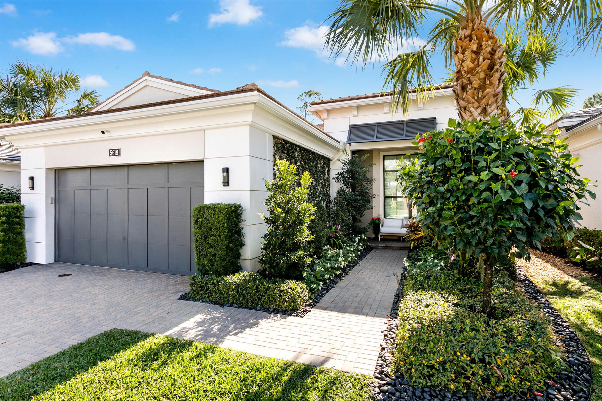 This exceptional 3 bedroom and den home offers a rare combination of luxury, privacy, and meticulous maintenance, making it a true standout. Located in the heart of Palm Beach Gardens, it boasts premium features and is nestled in a quiet, serene preserve.  The beautiful backyard and patio area include artificial turf, a pool and hot tub, and an outdoor kitchen equipped with a custom built-in grill, extra burners, and a refrigerator for ultimate convenience. The automatic porch screens add a unique touch for enjoying the outdoors. The interior features a generous open living area with great light and flow. Professionally designed finishes are throughout, including high-end cabinetry, intricate wood ceilings and moldings, designer wallpaper, plantation shutters, and elegant custom built-ins The master bedroom features a large closet complete with custom California Closet installations. LED lighting highlights the home's beauty and enhances its ambiance. Adding to the ease and convenience of this home is a full house generator and a beautiful air conditioned garage with custom cabinetry and finished floor. This is a special residence - turnkey for its next lucky owner!